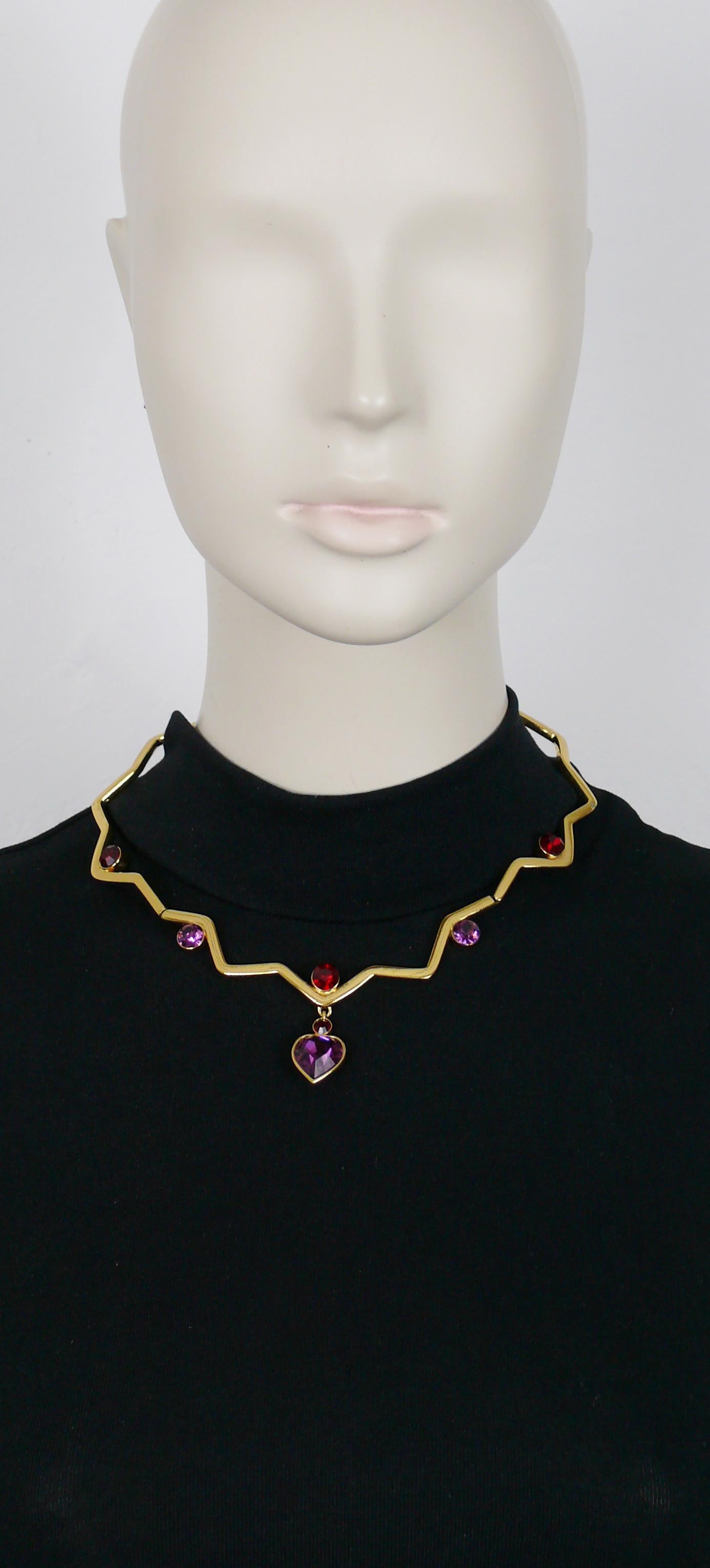 YVES SAINT LAURENT vintage gold toned articulated zig zag design necklace embellished with red and purple crystals, featuring a purple heart shaped crystal pendant.

T-bar and heart toggles closure.

Embossed YSL Made in France.
YVES SAINT LAURENT