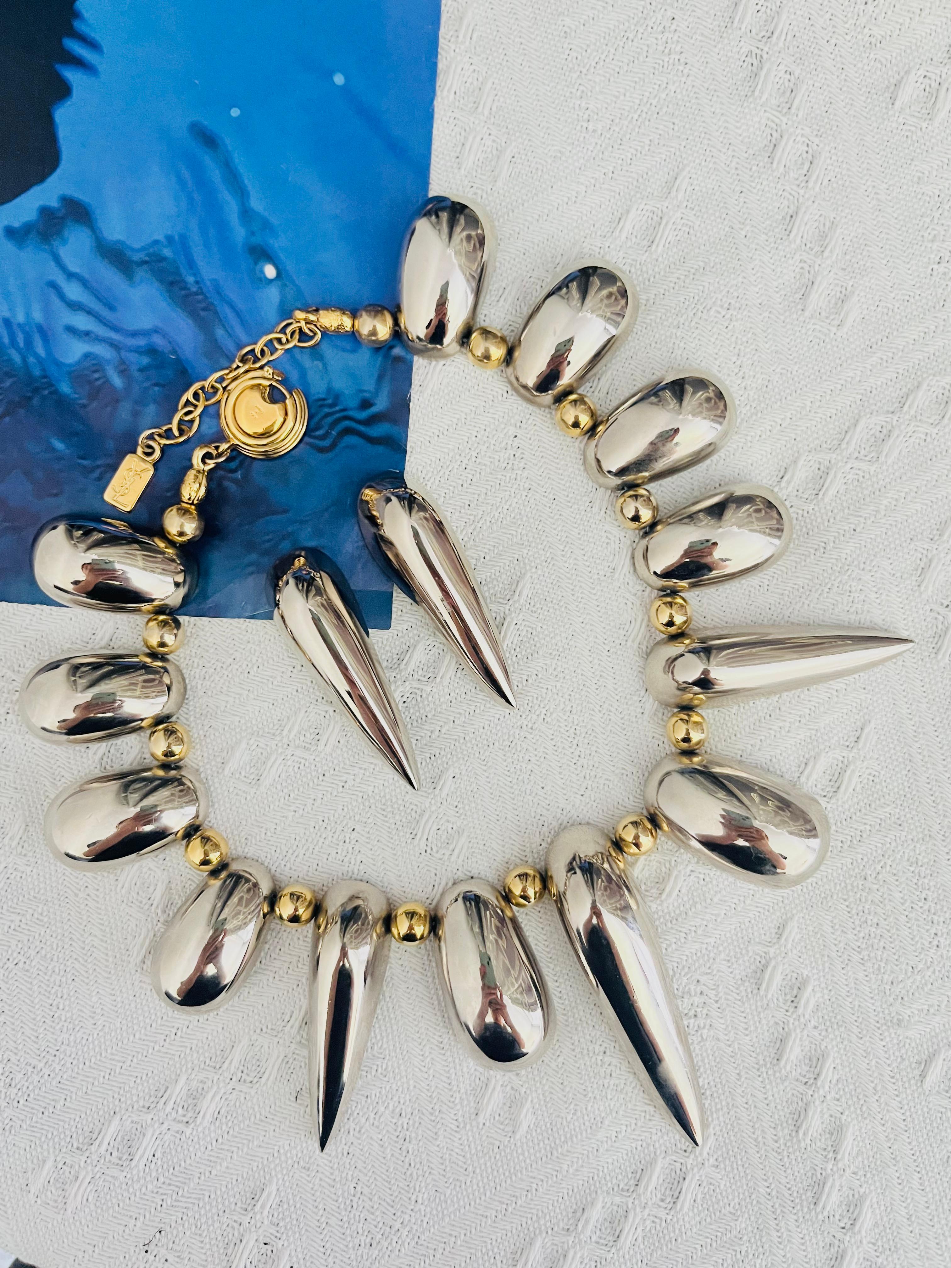 Yves Saint Laurent YSL Vintage Unisex High Collection Triangle Rivet Oval Charms Gold Balls Glow Dome Chunky Statement Necklace Earrings Jewellery Set, Gold Tone

Very good condition. Maybe light scratches or colour loss, barely noticeable. Unique