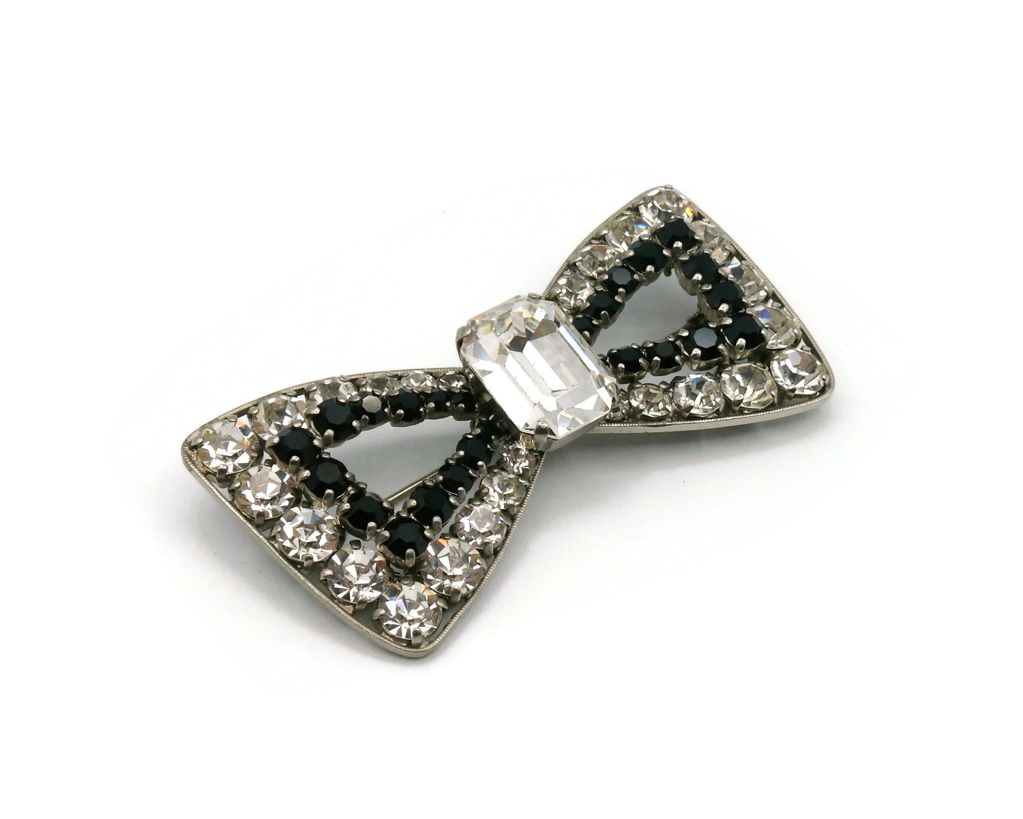 YVES SAINT LAURENT vintage bow brooch embellished with black and clear crystals.

Silver tone metal hardware.

Embossed YSL.

Indicative measurements : max. height approx. 3.6 cm (1.42 inches) / max. width approx. 7.2 cm (2.83 inches).

NOTES
- This