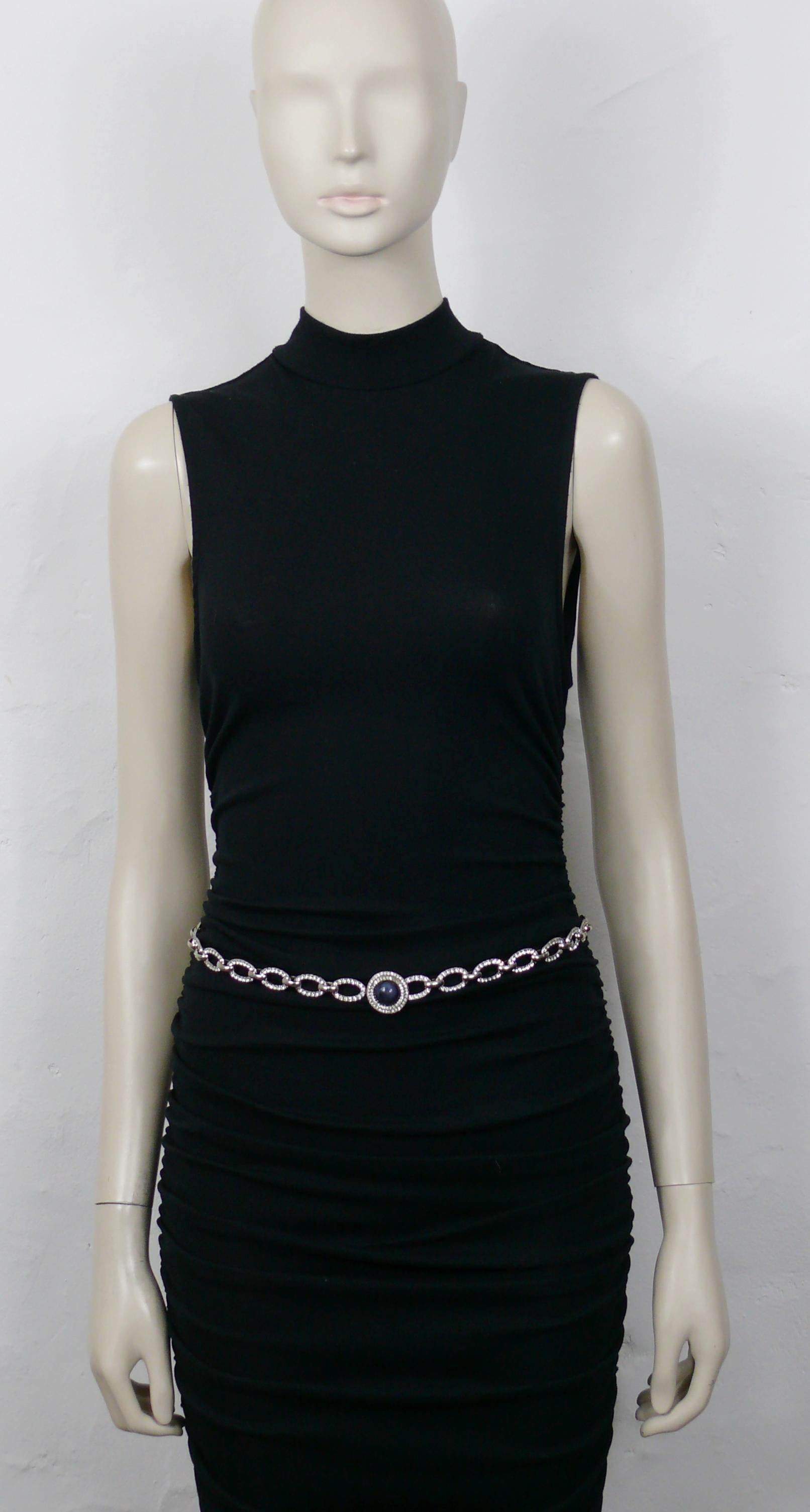 YVES SAINT LAURENT vintage 1970 silver tone chain belt featuring oval links embellished with clear crystals and a marbled blue glass cabochon.

Similar model in the collections of the METROPOLITAN MUSEUM OF ART in NEW YORK.

Embossed YSL on the
