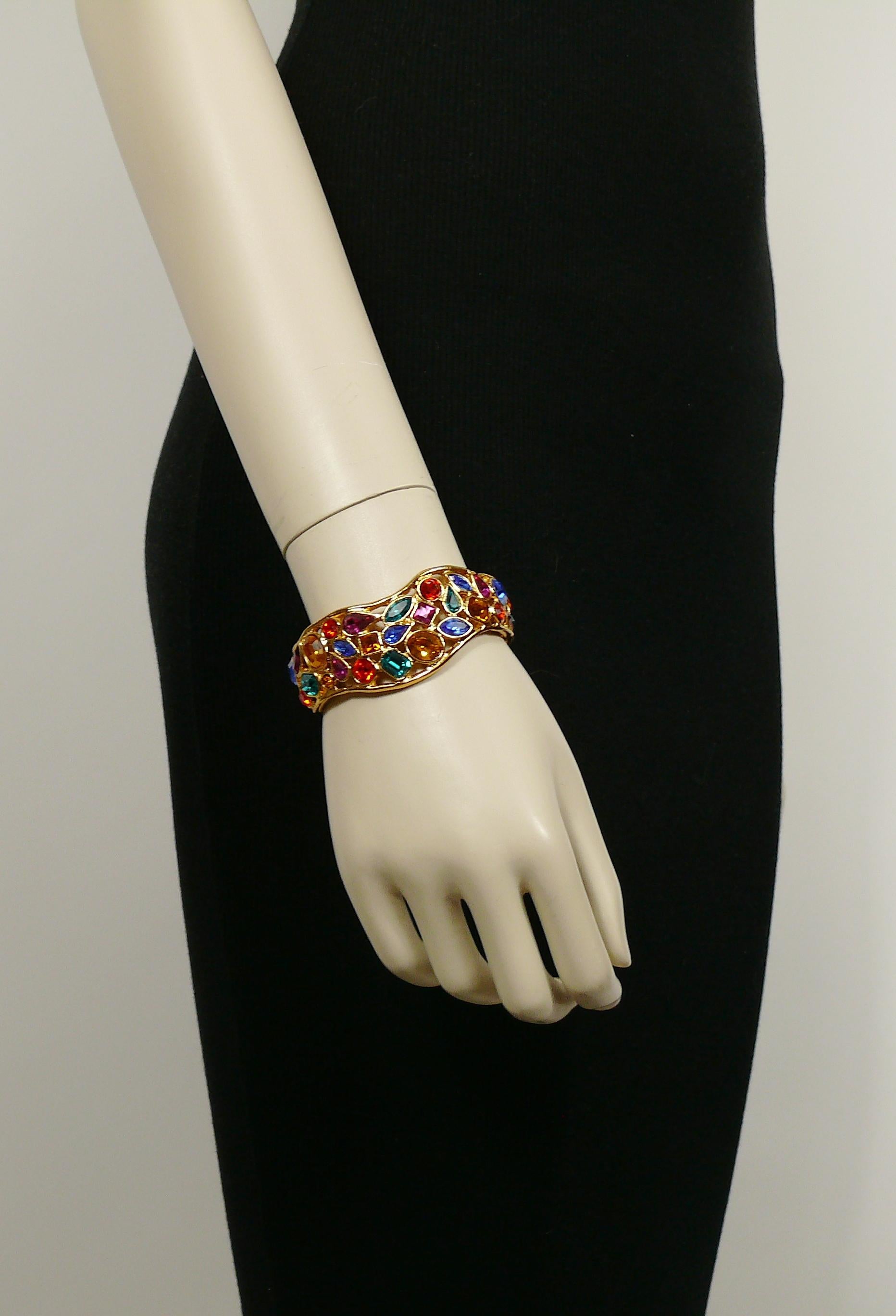 YVES SAINT LAURENT vintage openwork gold toned cuff bracelet embellished with multicolored crystals.

Marked YSL Made in France.

Indicative measurements : inner measurements approx. 6 cm x 5.3 cm (2.36 inches x 2.09 inches) / max. width approx. 2.5