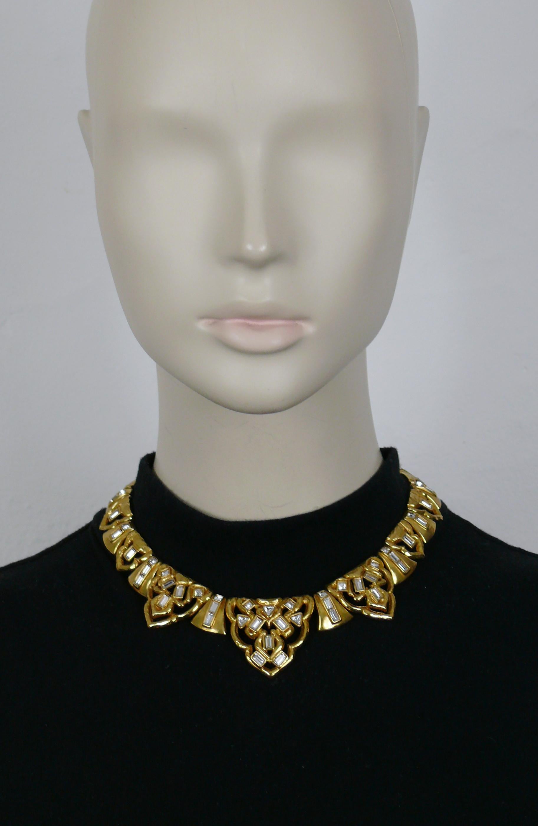 YVES SAINT LAURENT vintage gold tone oriental design link necklace embellished with clear crystals.

Adjustable spring clasp closure.

Embossed YSL Made in France.

Indicative measurements : adjustable circumference from approx. 36.12 cm (14.22