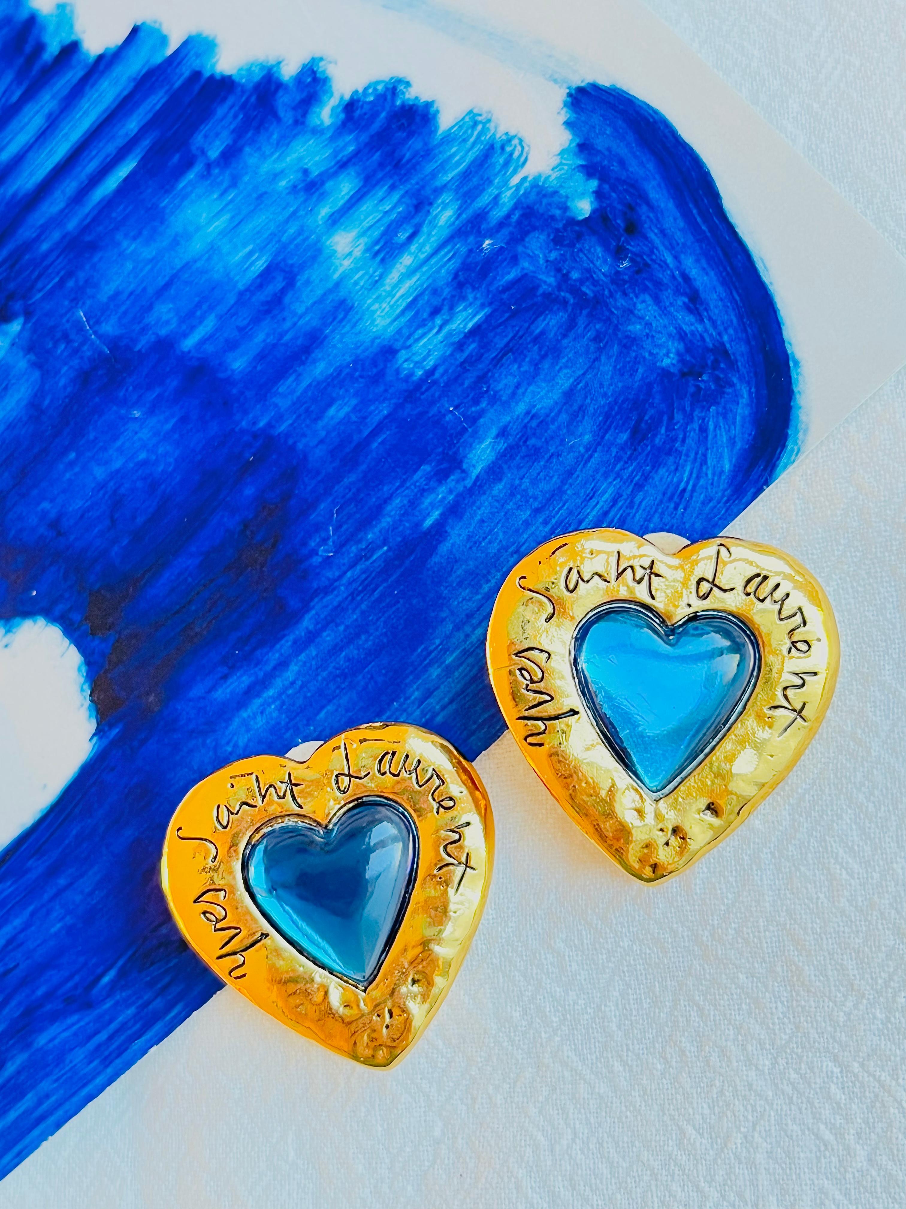 Yves Saint Laurent YSL Vintage Large Gripoix Logo Sapphire Clear Blue Heart Clip Earrings, Gold Tone

Vintage and very rare to find. 100% Genuine. Signed at the rear.

Very excellent condition. Come with original box.

Size: 3.2*3.3 cm.

Weight: