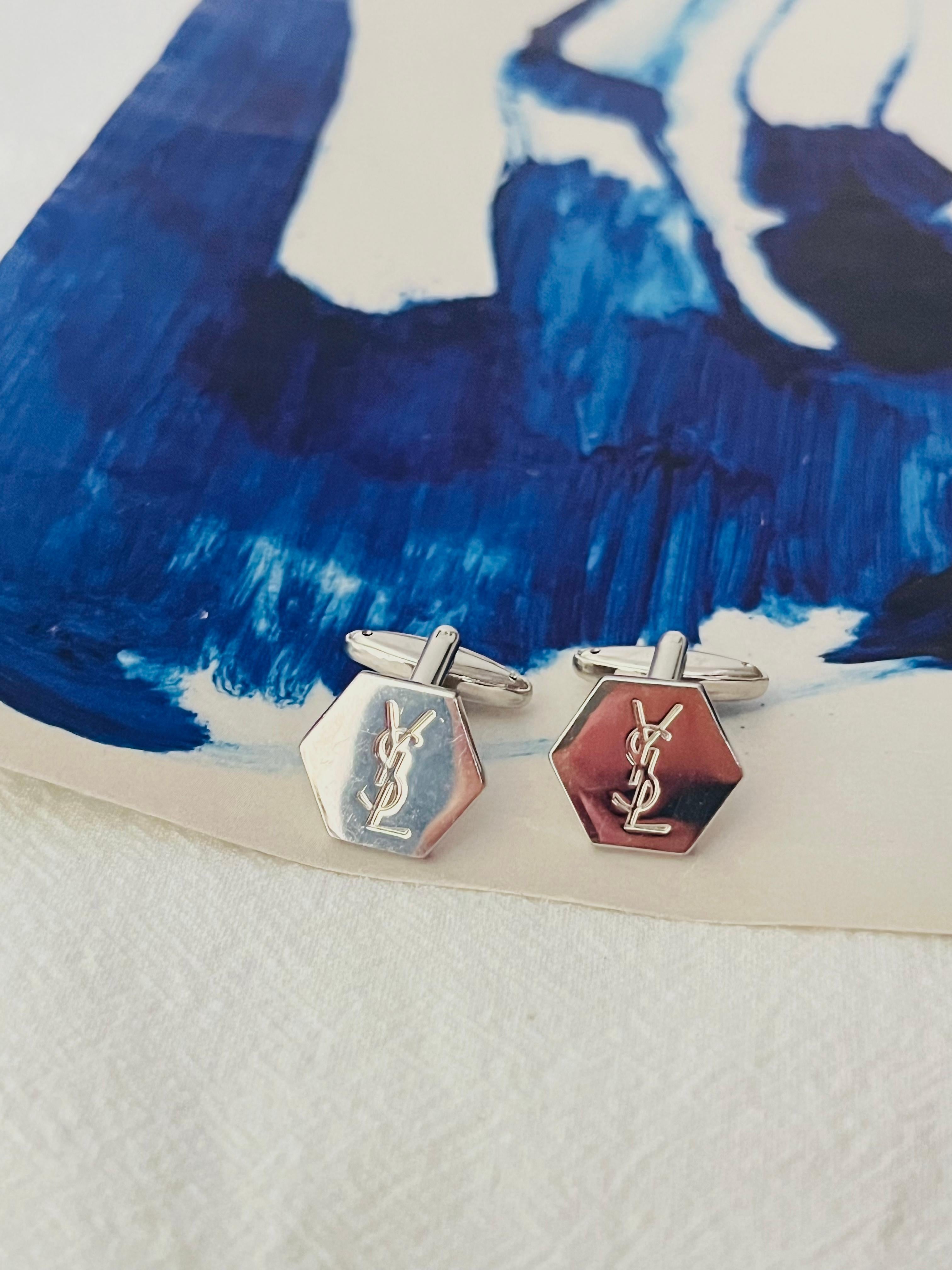 Yves Saint Laurent YSL Vintage Logo Iconic Classic Hallmark Monogram Hexagon Cufflinks, Silver Plated

Very excellent condition. Some Light scratches, barely noticeable. 100% Genuine.

Hexagon pendant size: 1.5*1.7 cm.

Weight: 5 g/each.

_ _