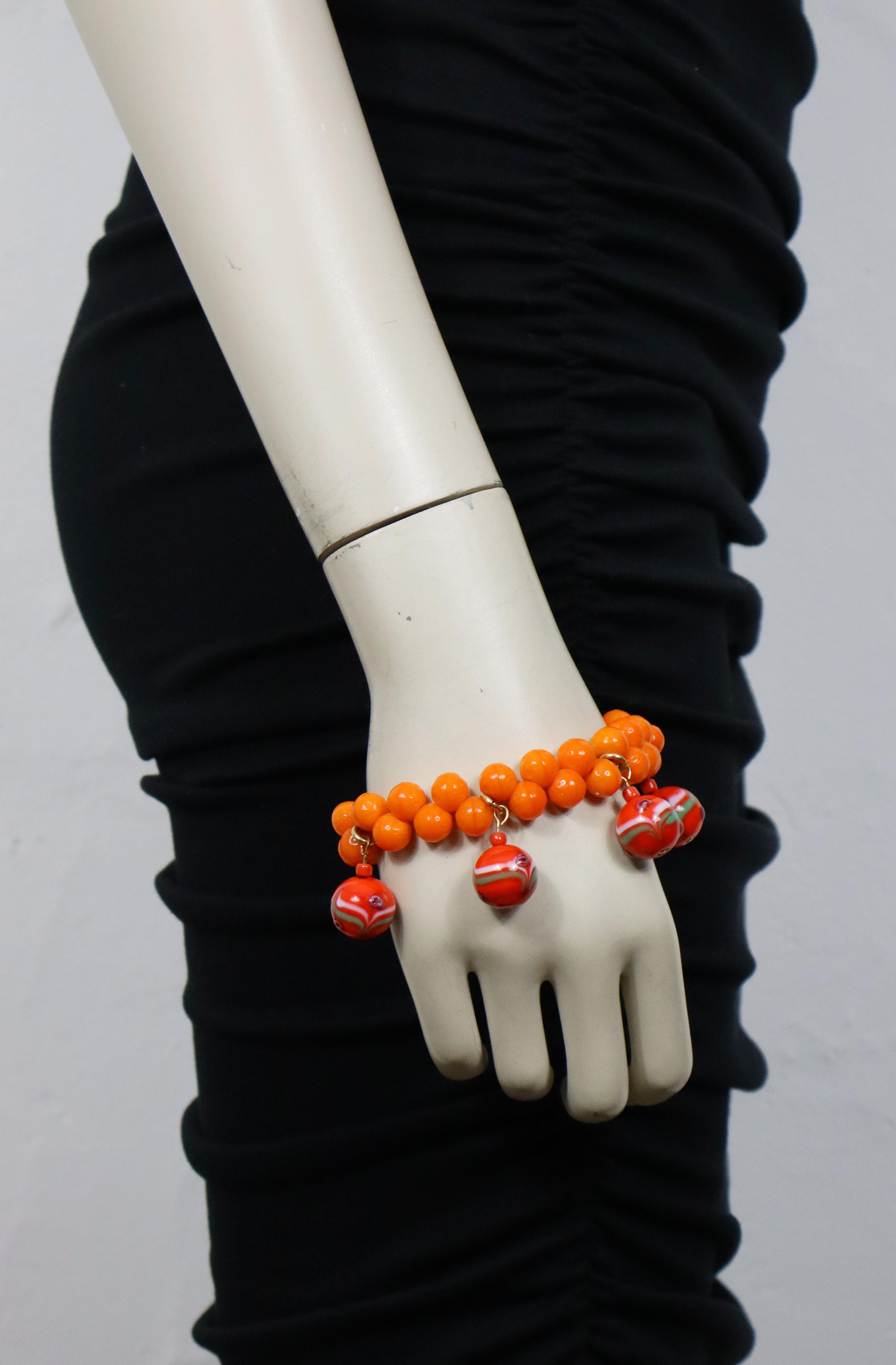 YVES SAINT LAURENT vintage mandarin bead bracelet embellished with glass ball charms.

Gold tone metal hardware.

Adjustable toggle clasp closure.

Embossed YVES SAINT LAURENT on the heart rings.
Made in France.

Indicative measurements : adjustable