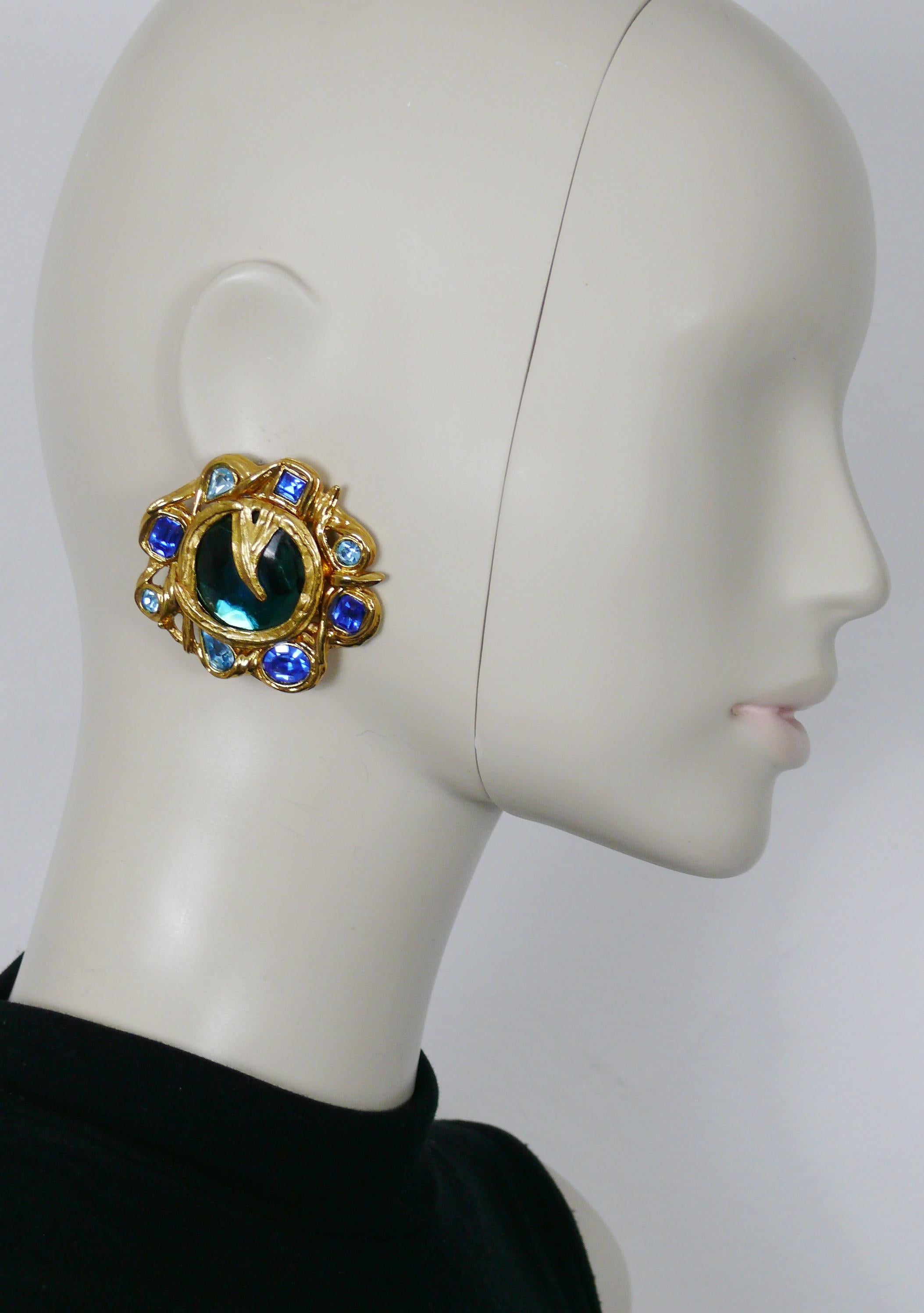 YVES SAINT LAURENT vintage massive CADIX gold toned clip-on earrings embellished with blue shade crystals and a blue resin cabochon.

Embossed YSL Made in France.

Indicative measurements : width approx. 5.2 cm (2.05 inches) / height approx. 5 cm