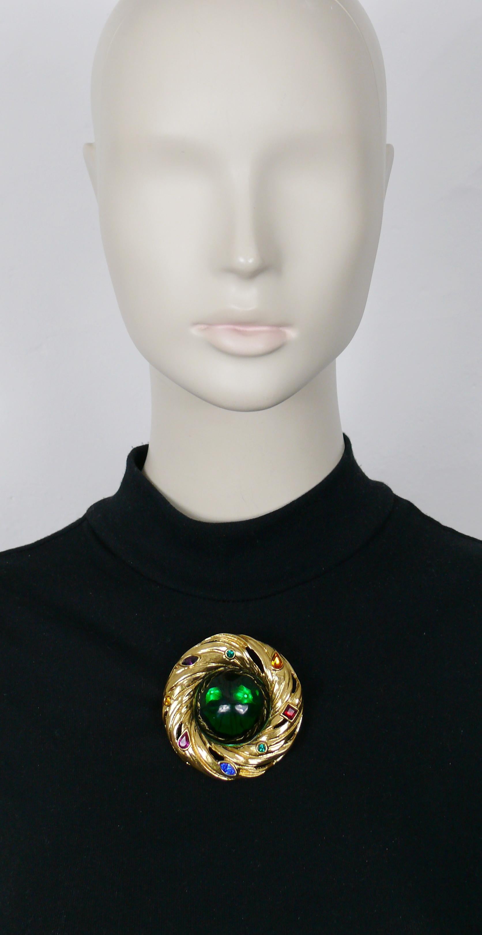 YVES SAINT LAURENT vintage massive gold tone nest design brooch/pendant embellished with a large irregular shaped green resin cabochon adorned with multicolored crystals.

Can be worn as a brooch or pendant.

Embossed YSL Made in France.

Indicative