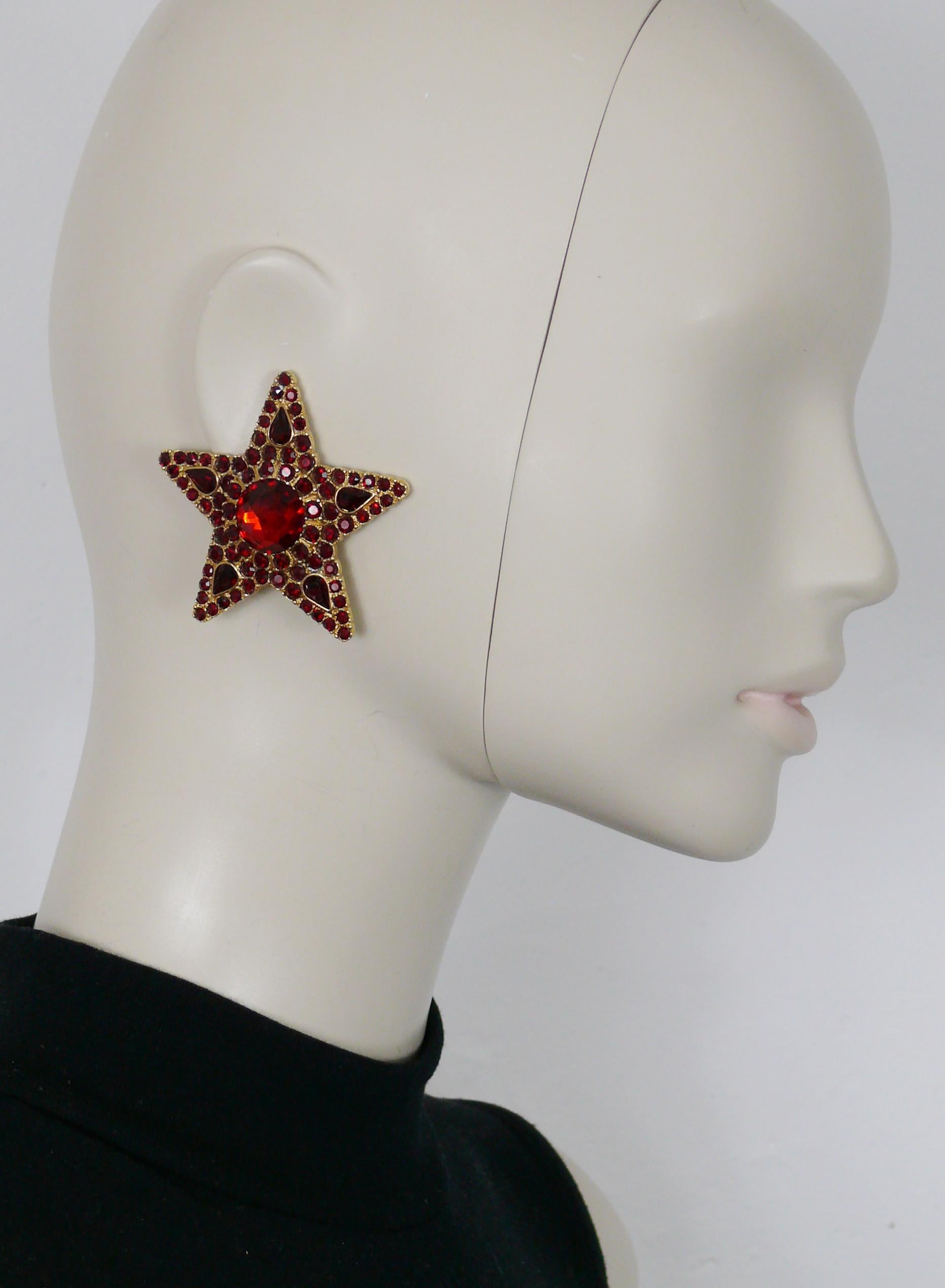 Boucles d'oreilles à clip YVES SAINT LAURENT vintage massif en forme d'étoile dorée, ornées de cristaux de couleur rubis.

Gaufrage YSL Made in France.

Mesures indicatives : environ 5,5 cm x 5,5 cm (2,17 pouces x 2,17 pouces).

Poids : environ 25