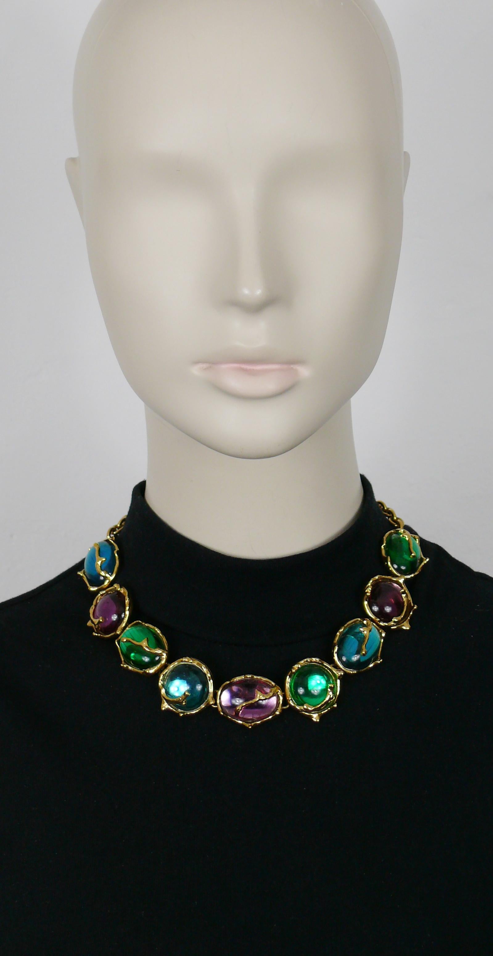YVES SAINT LAURENT vintage gold tone necklace featuring round and oval multicolored (blue, purple, green) cabochons.

T bar and heart toggle closure.
Adjustable length.

Embossed YSL Made in France.
Cursive signature YVES SAINT LAURENT embossed on