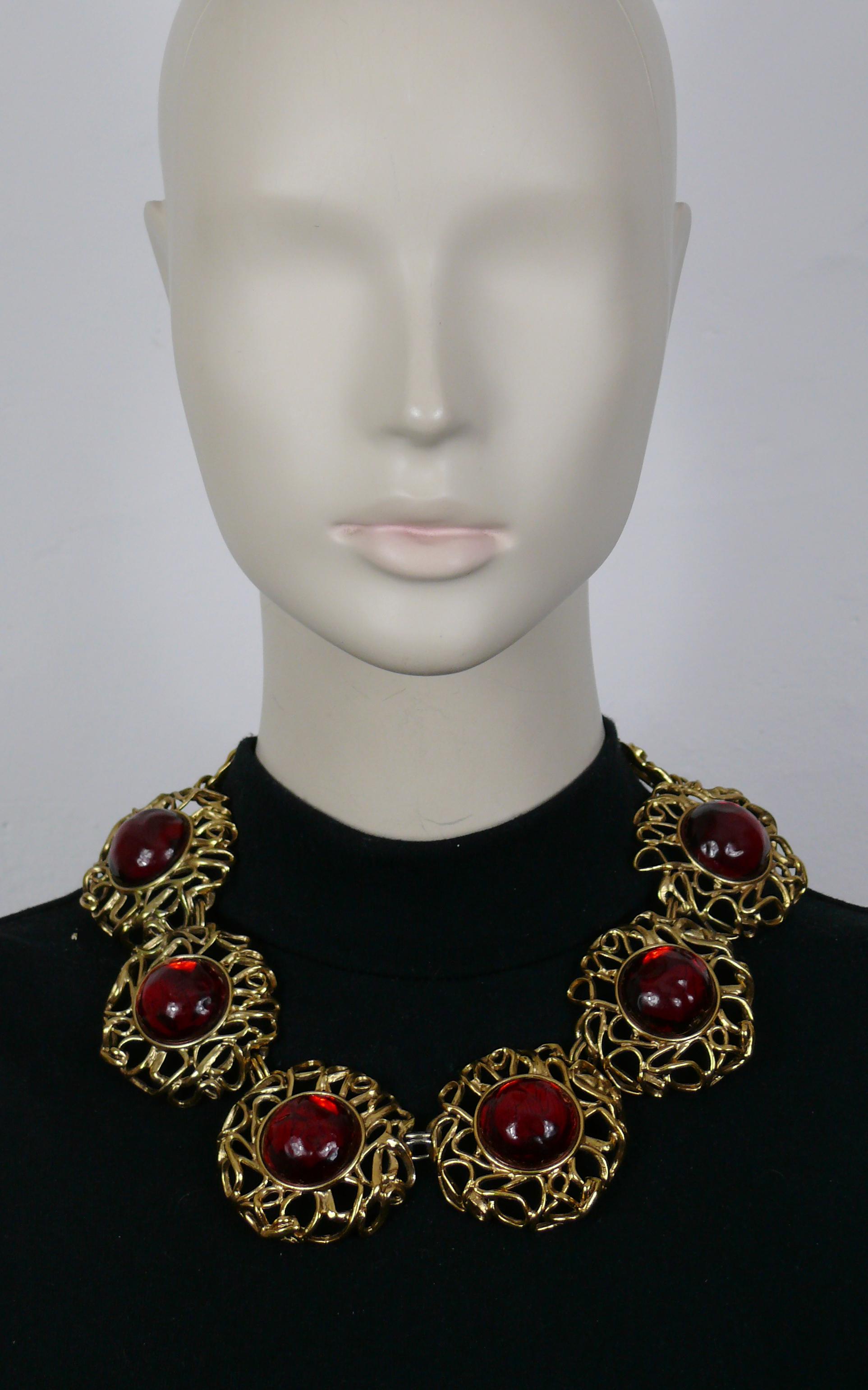 YVES SAINT LAURENT vintage gold tone necklace featuring large openwork round links embellished with irregular shaped red resin cabochons.

Adjustable hook clasp closure.

Embossed YVES SAINT LAURENT Rive Gauche Made in France.

Indicative