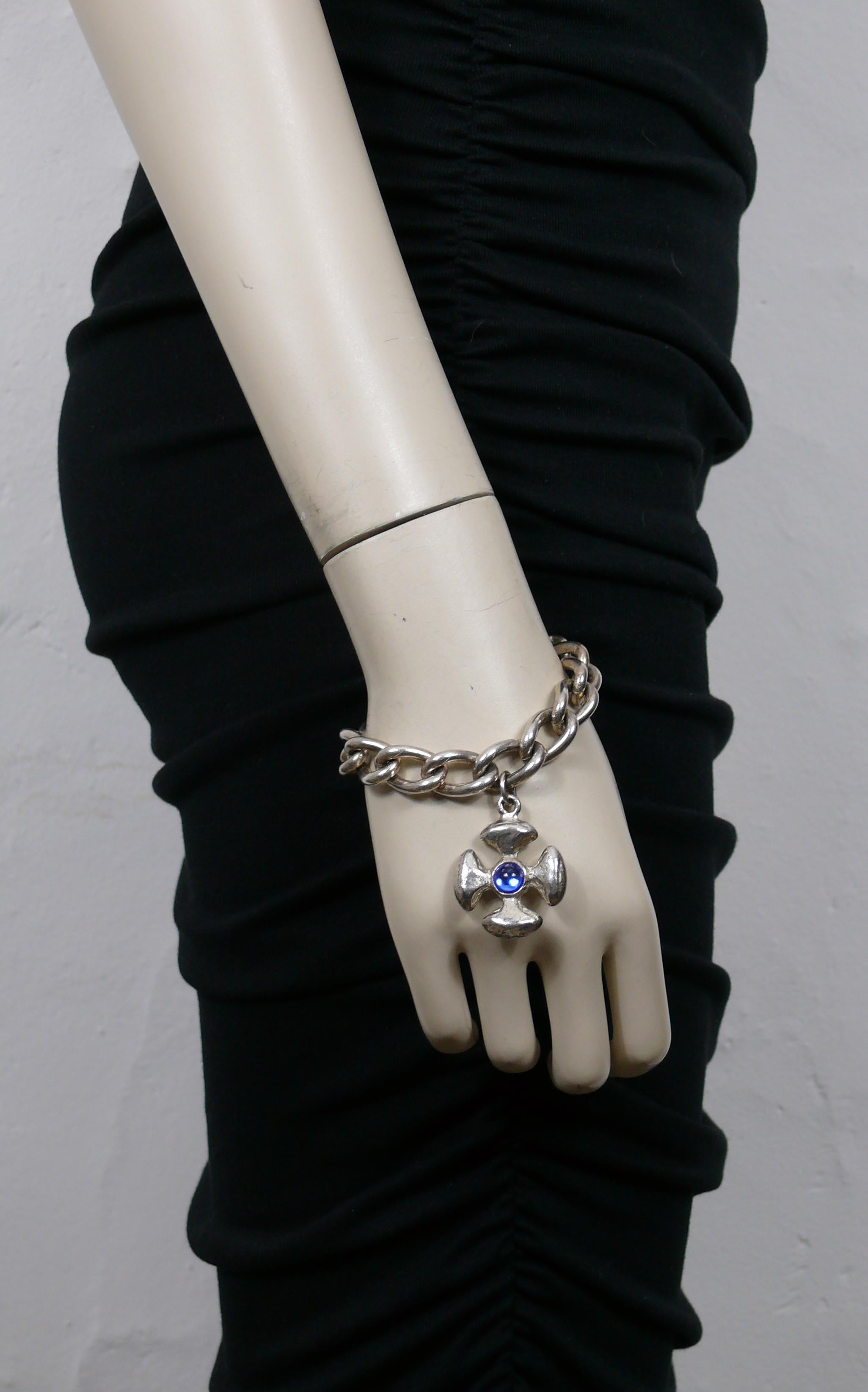 YVES SAINT LAURENT vintage silver tone chain bracelet featuring a Maltese cross charm embellished with blue glass cabochons.

T-bar and love heart toggle clasp closure.

Embossed  YVES SAINT LAURENT Made in France.

Indicative measurements : length