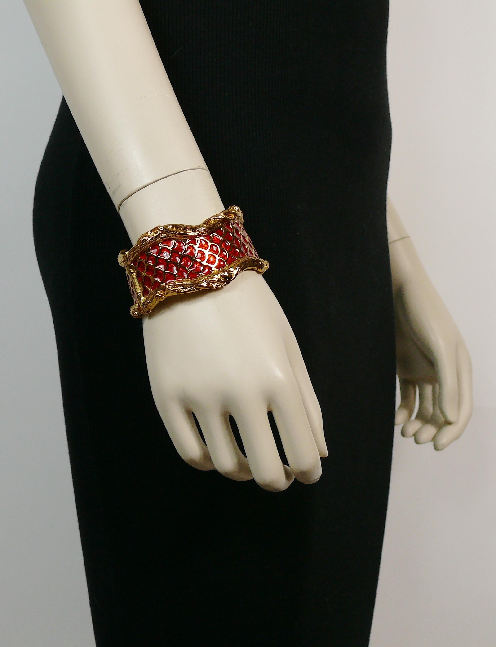 YVES SAINT LAURENT vintage gold toned bracelet featuring coiled snakes/serpents embellished with red enamel.

Embossed YSL Made in France.

Indicative measurements : inner measurements approx. 5.7 cm x 5 cm (2.24 inches x 1.97 inches) / width