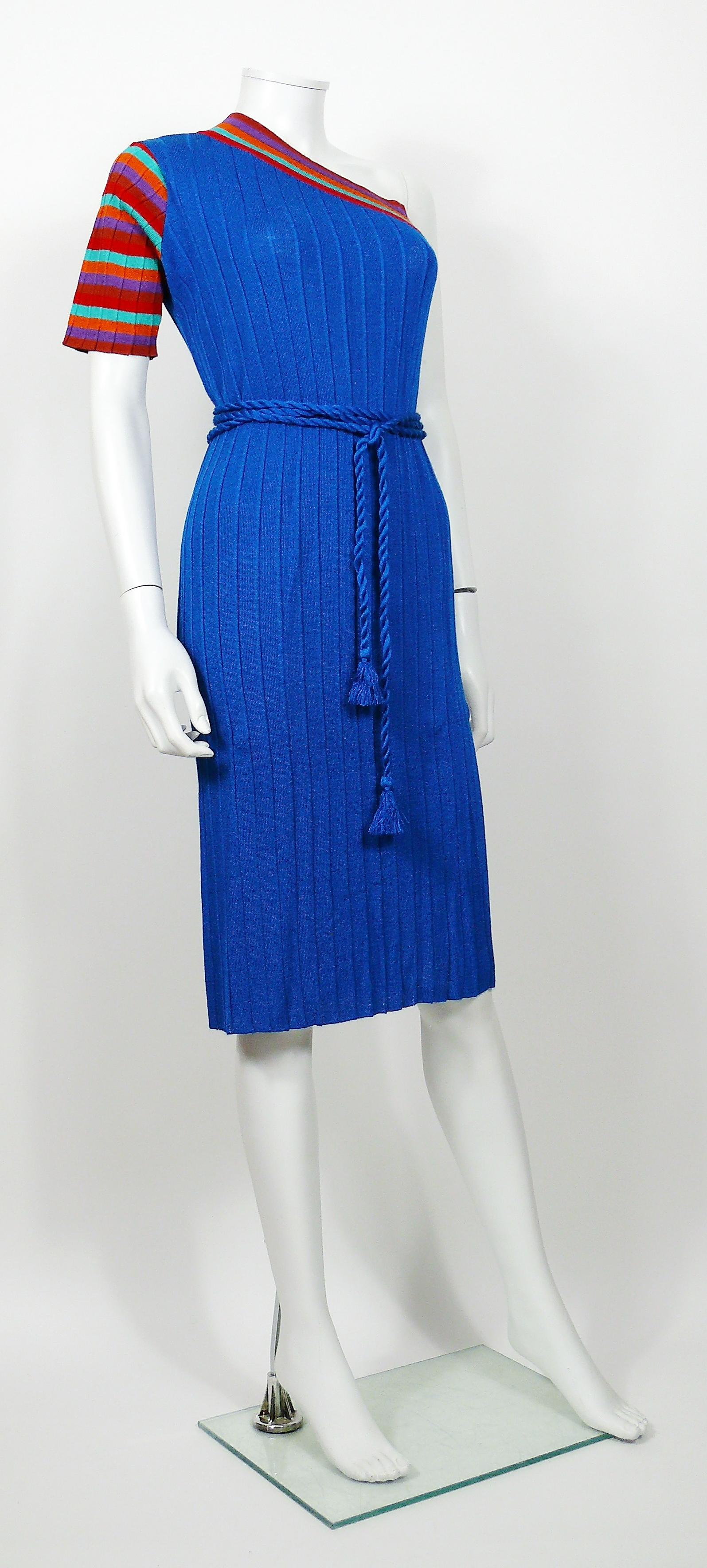 YVES SAINT LAURENT vintage tricot dress. 

This dress features :
- Knitted fabric in blue with colorful stripes on the neckline, sleeve and side slit.
- Straight cut.
- One shoulder.
- Side slit.
- Original matching tassel belt.

Label reads YVES