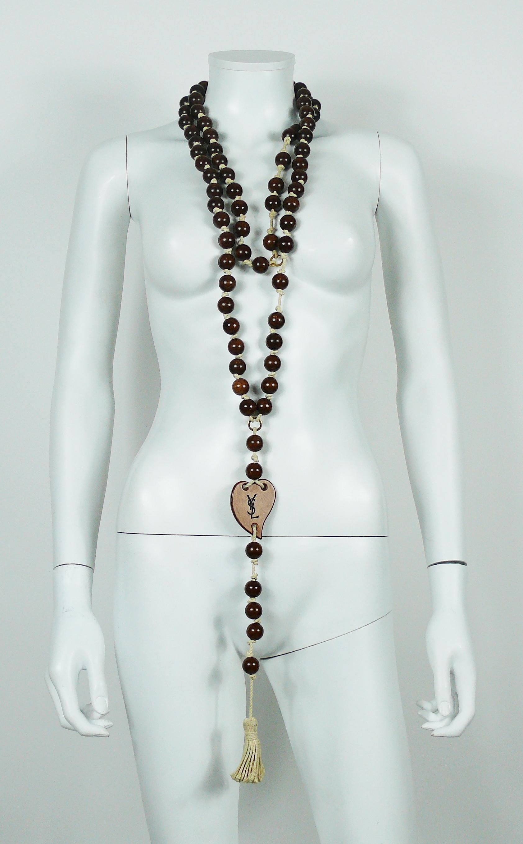 YVES SAINT LAURENT off-white rope tassel necklace featuring natural wood beads and heart.

Extra long length.
Slips on.

Embossed YSL on the heart.

Indicative measurements : length incl. tassel approx. 127 cm (50 inches).
Please note that we have