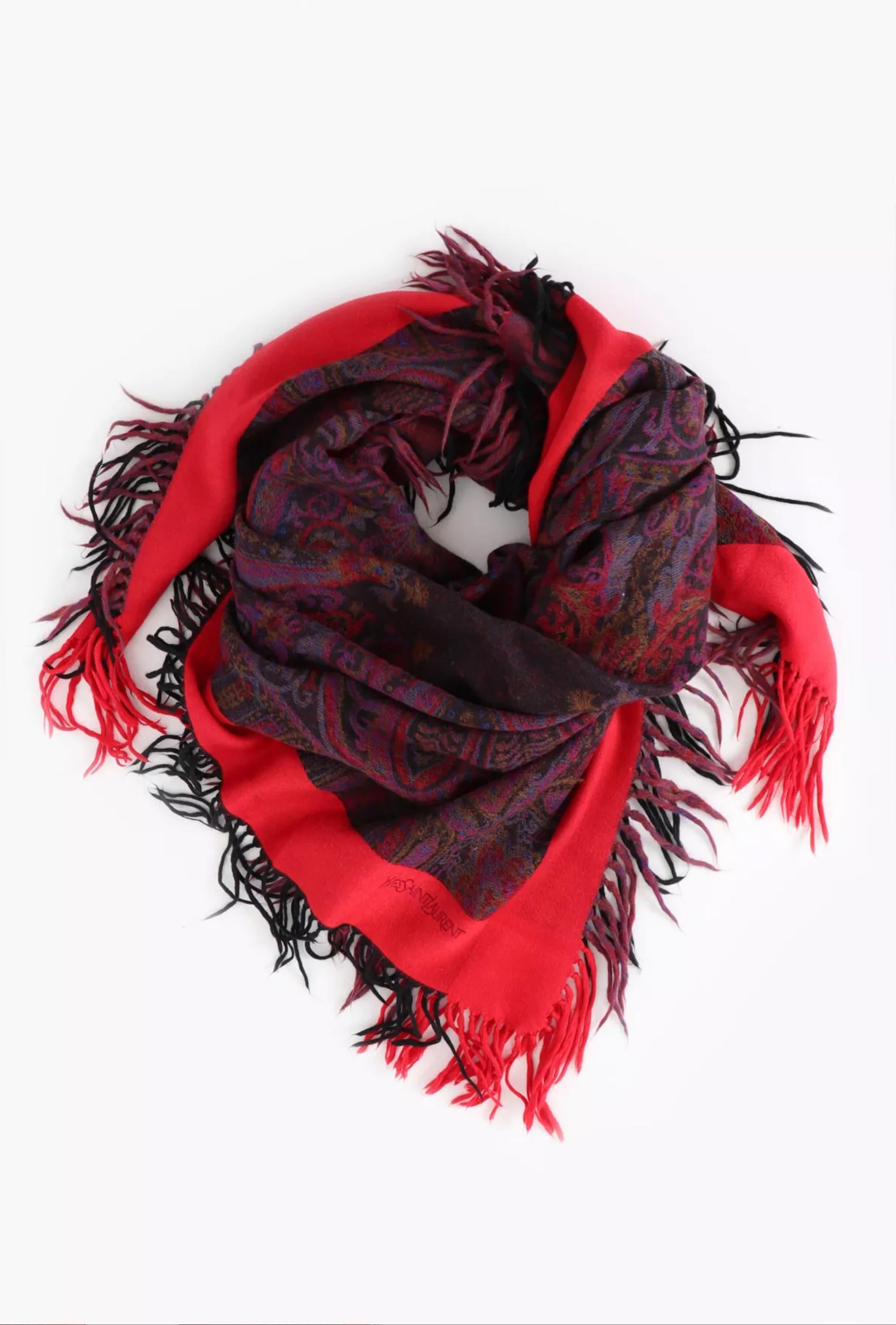 Purple wool scarf from Saint Laurent YSL featuring a paisley motif, fringed tassel trim & an embroidered top logo signature. 100% wool. 
Circa 1970s  
In good vintage condition. Made in France.
53.5 in. (136cm) X 51.3in. (130cm)
We guarantee you