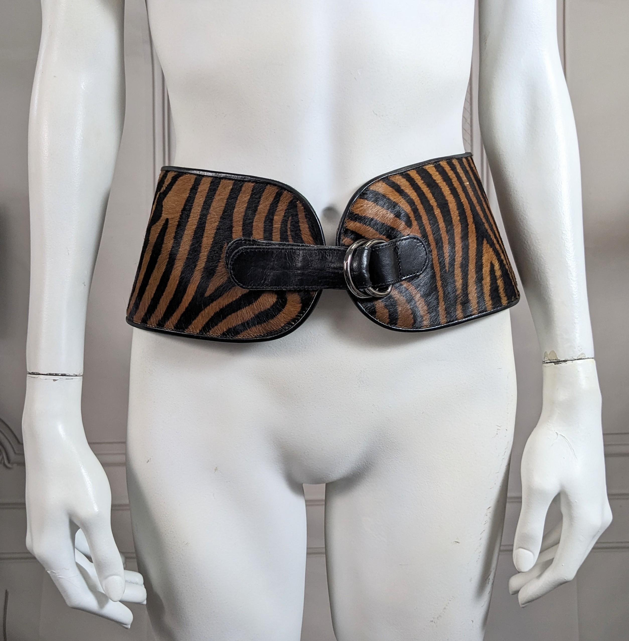 Yves Saint Laurent Wide Waist Belt in Zebra Print Pony Skin from the 1980's. Wide curved shape with gunmetal D ring buckles and leather tab. Sits widely on waist over hips. Lined in calf leather. Size Small. Closed Waist 23, Hip area 32