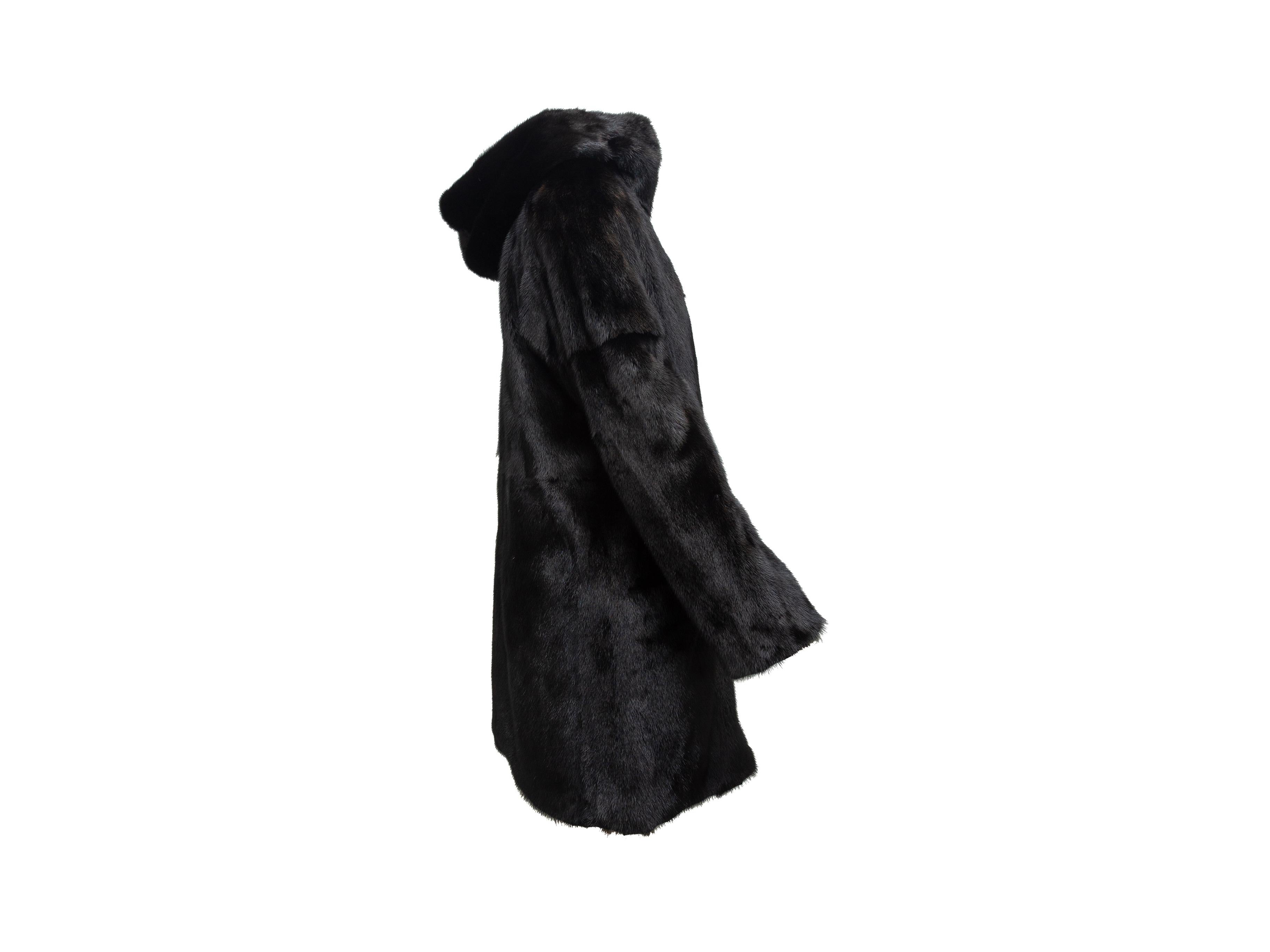 Product details: Black reversible mink hooded coat by Yves Salomon. From the Army Collection. Pockets at hips. Zip closure at center front. 18