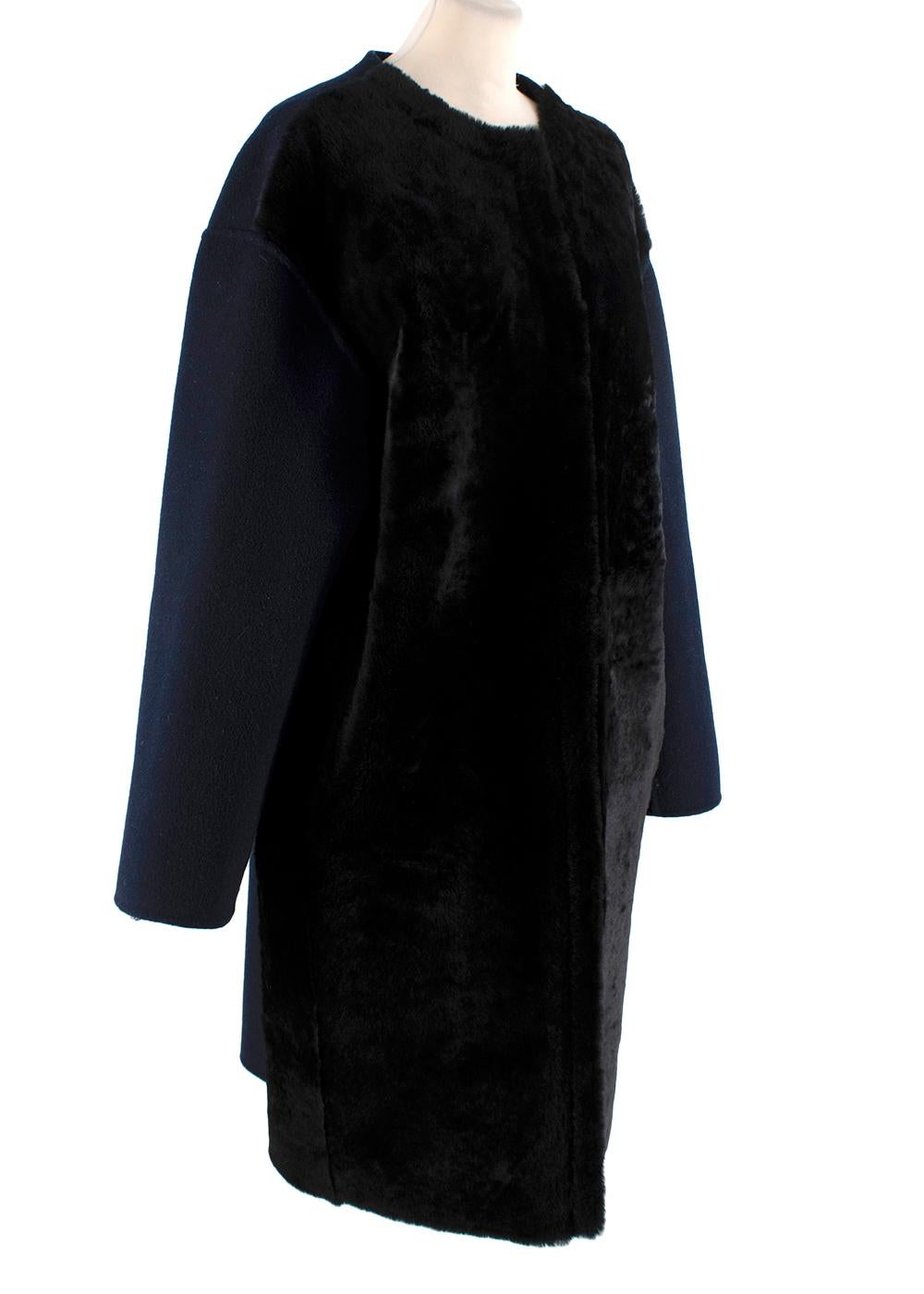 Yves Salomon Black Shearling & Navy Wool Coat

- Single-breasted collarless coat
- Panelled in black fur and navy wool 
- Two inset hip slip pockets 
- Snap front fastening 
- Interior leather sleeve lining

Materials 
90% Wool
10% Cashmere 
100%