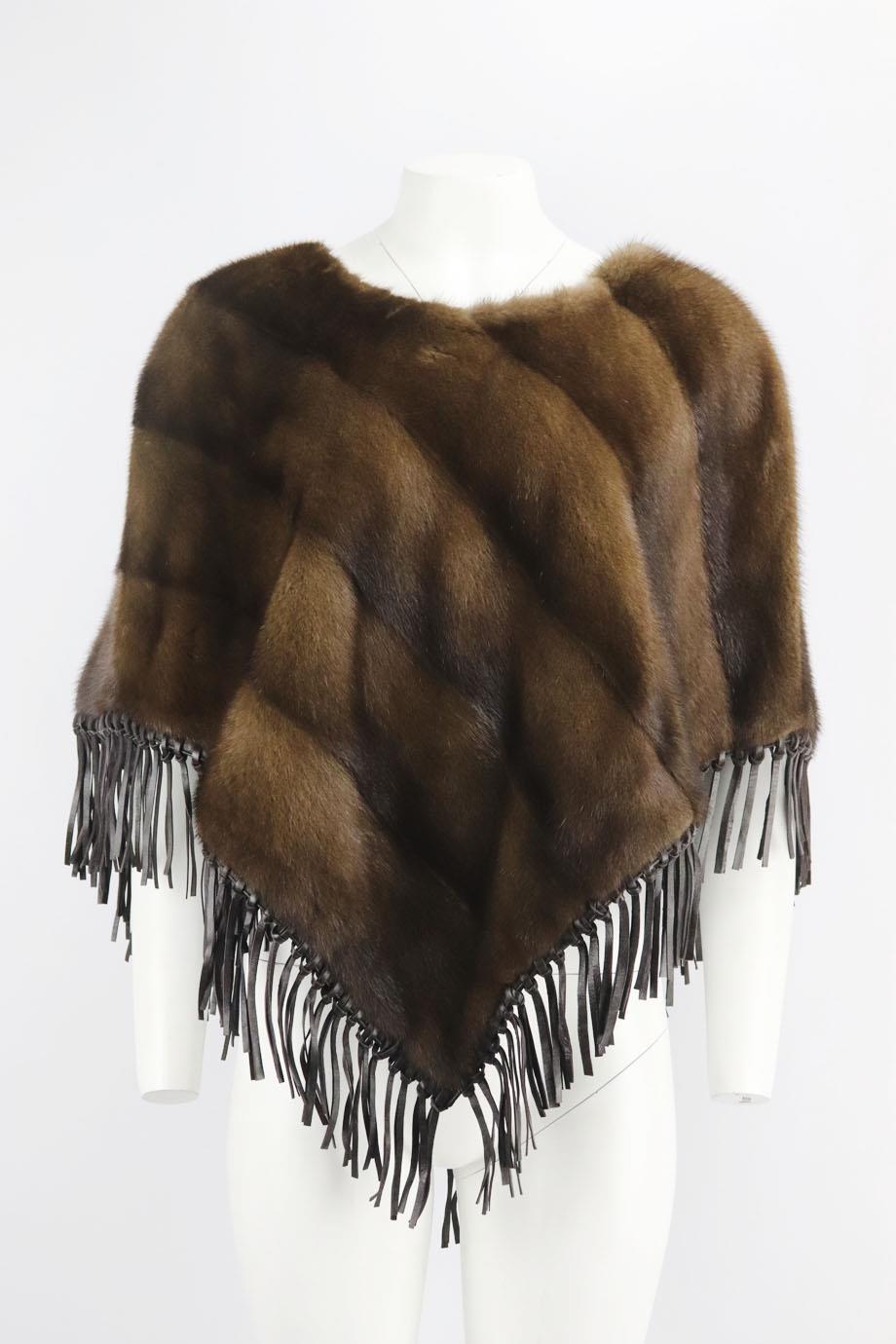 Yves Salomon fringed mink fur poncho. Brown. Long sleeve, crewneck. Slips on. 100% Leather; fabric2: 100% mink fur; lining: 100% silk. Size: One Size. Shoulder to shoulder: 17 in. Bust: 50 in. Length: 27 in
