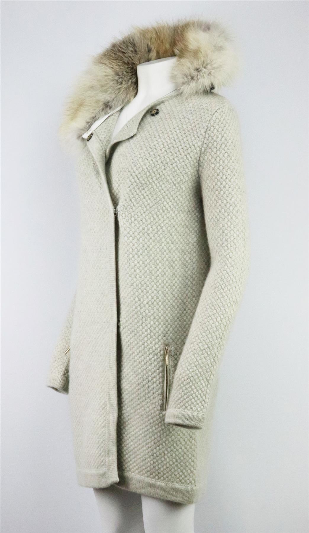 This cardigan by Yves Salomon is waffle-knitted with pure cashmere for an extra cosy handle, it has thick ribbed trims and oversized pockets at the front and finished fox-fur collar. Grey cashmere. Snap button fastening at front. 100% Cashmere;