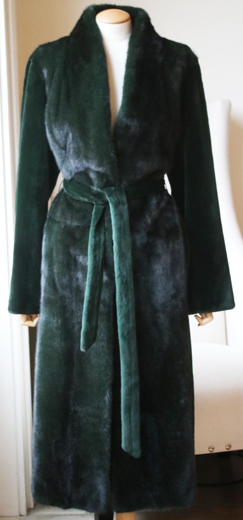 This Yves Salomon coat is rendered in mink fur and features an elongated silhouette and self tie belt at the waist. Featuring a high standing collar. Self tie belt. Long sleeves and a straight hem. Colour: Green. Made in France. 100% Mink. Lining: