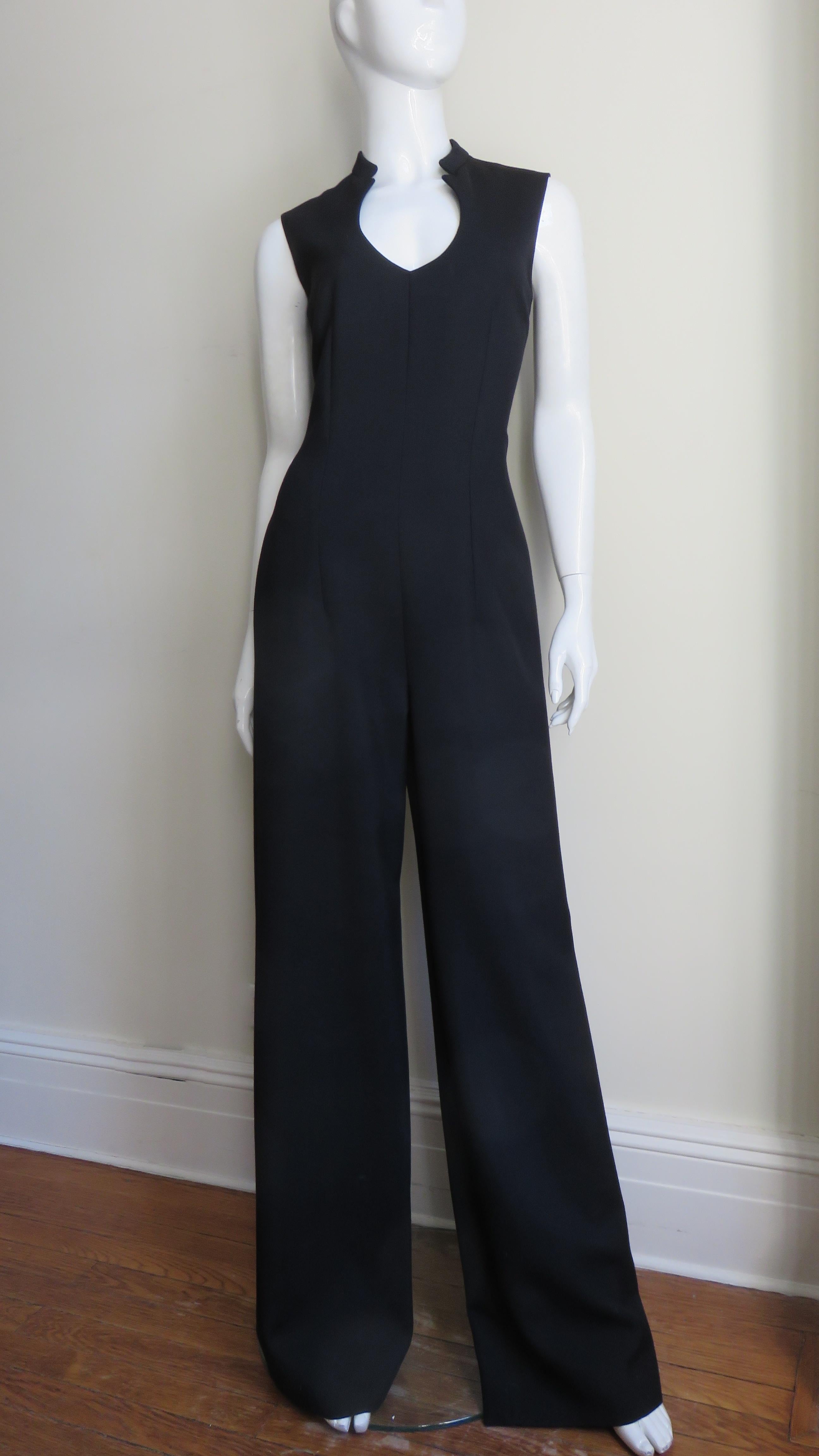 A fabulous black wool jumpsuit from the Yves St Laurent YSL A/W 2010 collection. It is sleeveless with a plunging neckline and a stand up collar. The jumpsuit is semi fitted with wide legs and a center back zipper.
Fits sizes Small, Medium. Marked