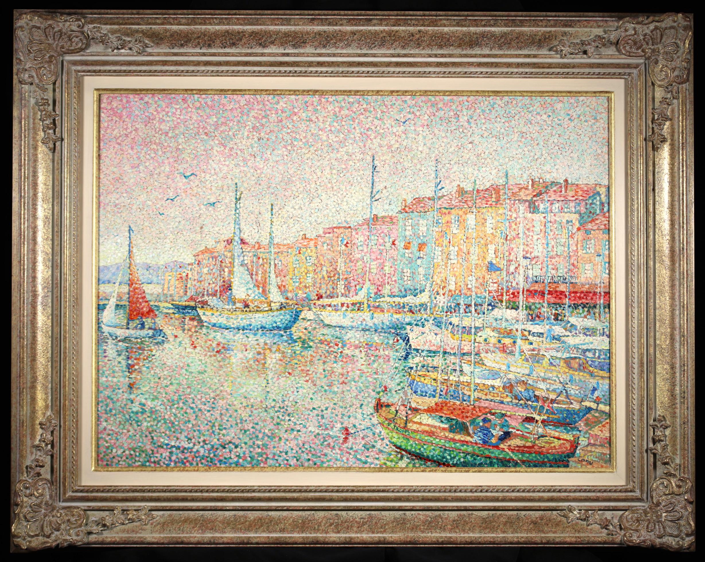 Signed and titled pointillist oil on cavas landscape by French painter Yvonne Canu. This stunning piece depicts boats moored at a harbour in Saint Tropez as the sun sets. There is a row of brightly painted houses behind the masts. A wonderful piece