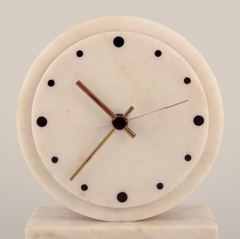 Swedish Yxhult Sten, Sweden. Tabletop clock in white marble with brass hands