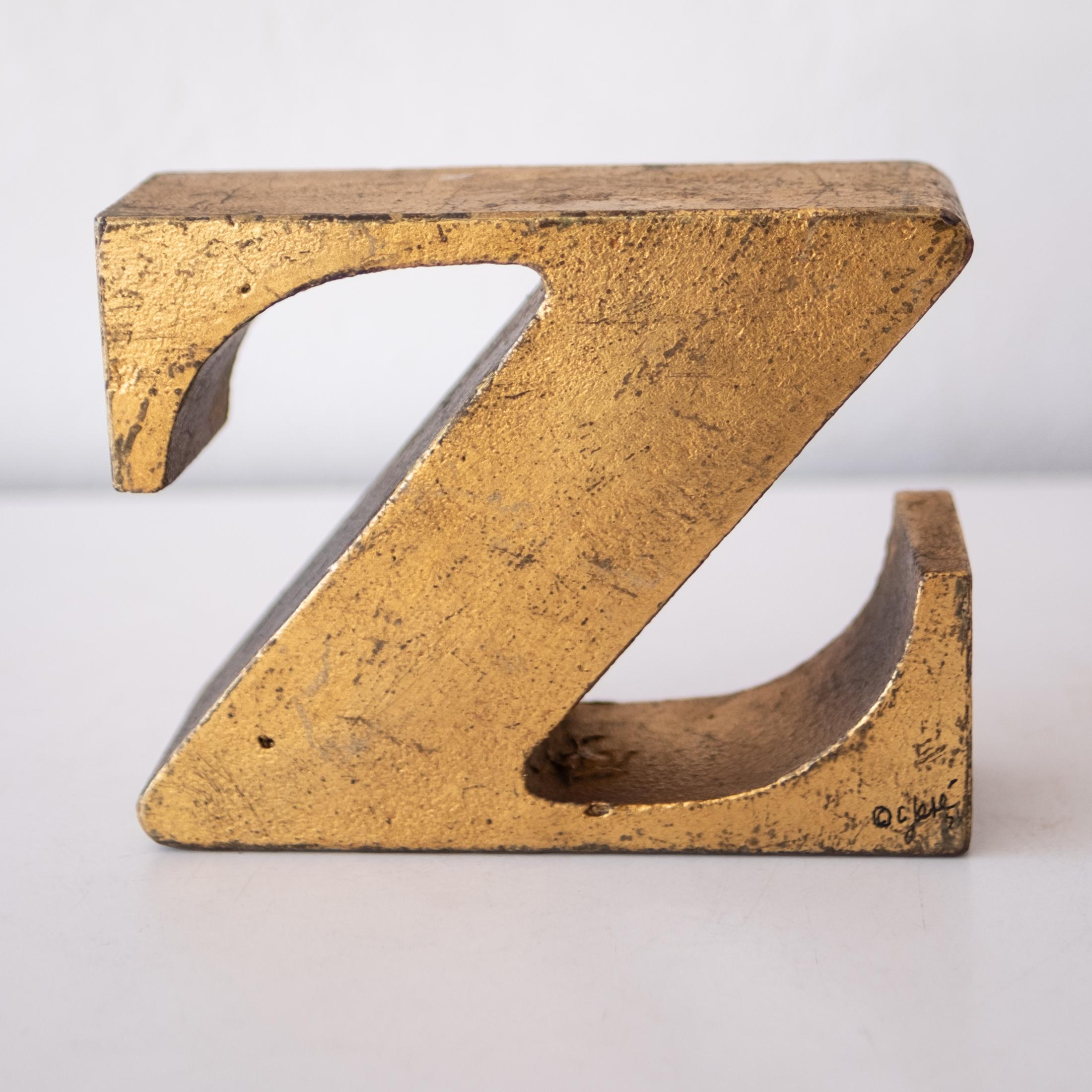 Solid iron midcentury Z Curtis Jere bookend with gold leaf finish.  Signed and dated 
