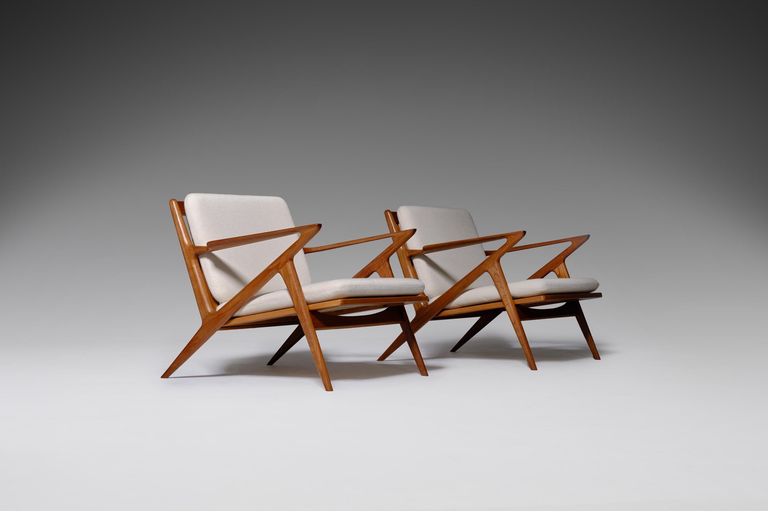 Mid-Century Modern lounge chairs by Poul Jensen for Selig, Denmark, 1960s. Stunning sculptural shaped frames out of warm colored solid teak with remarkable sharp lines that resembles the letter ‘Z'. Lots of beautiful details such as the elegant