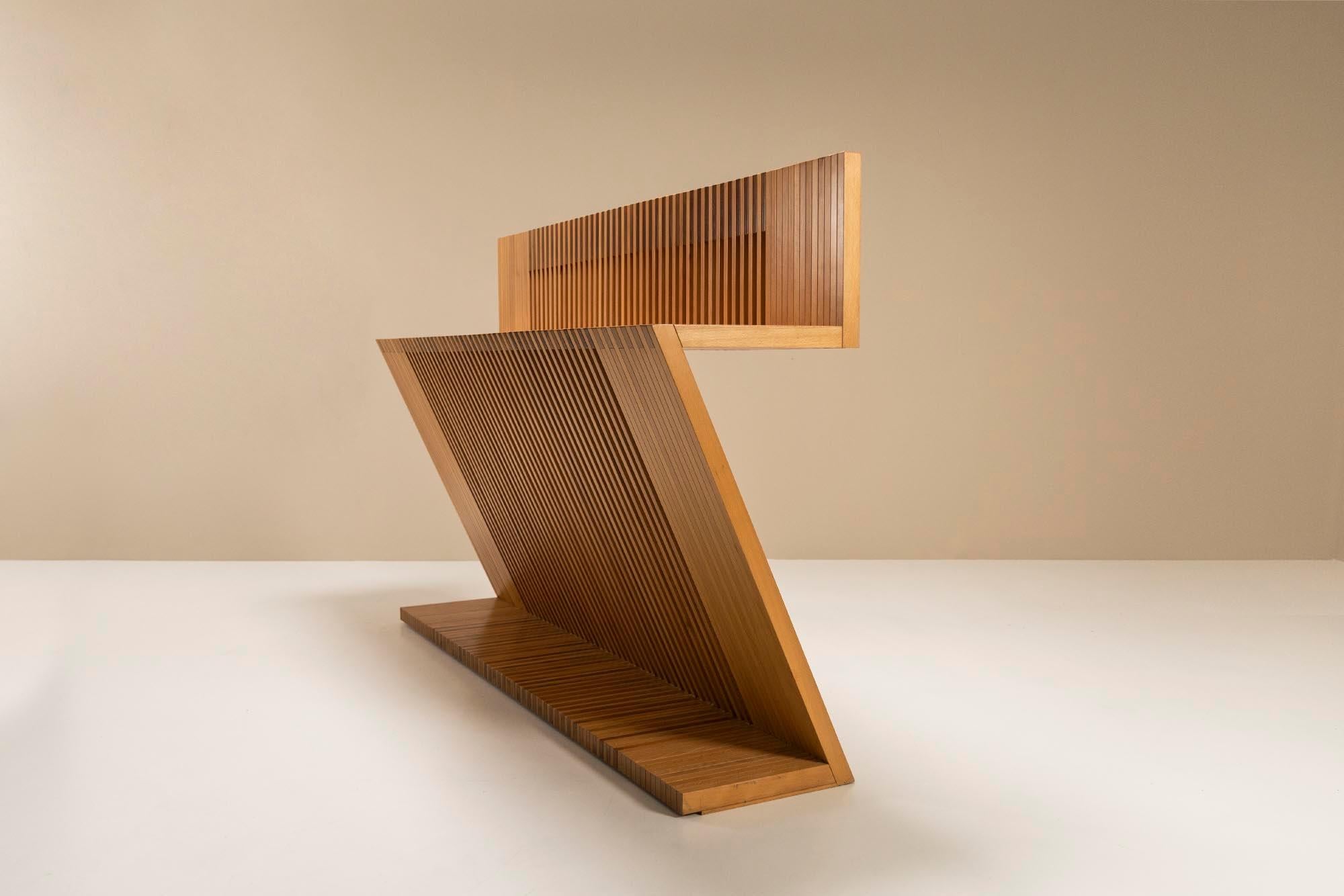 This Italian item from the 1980s can actually not only be categorized as a console but has a more ambiguous and hybrid character. Due to its z-shape and height, this piece can be used in various ways. It can therefore serve as a console, but you can
