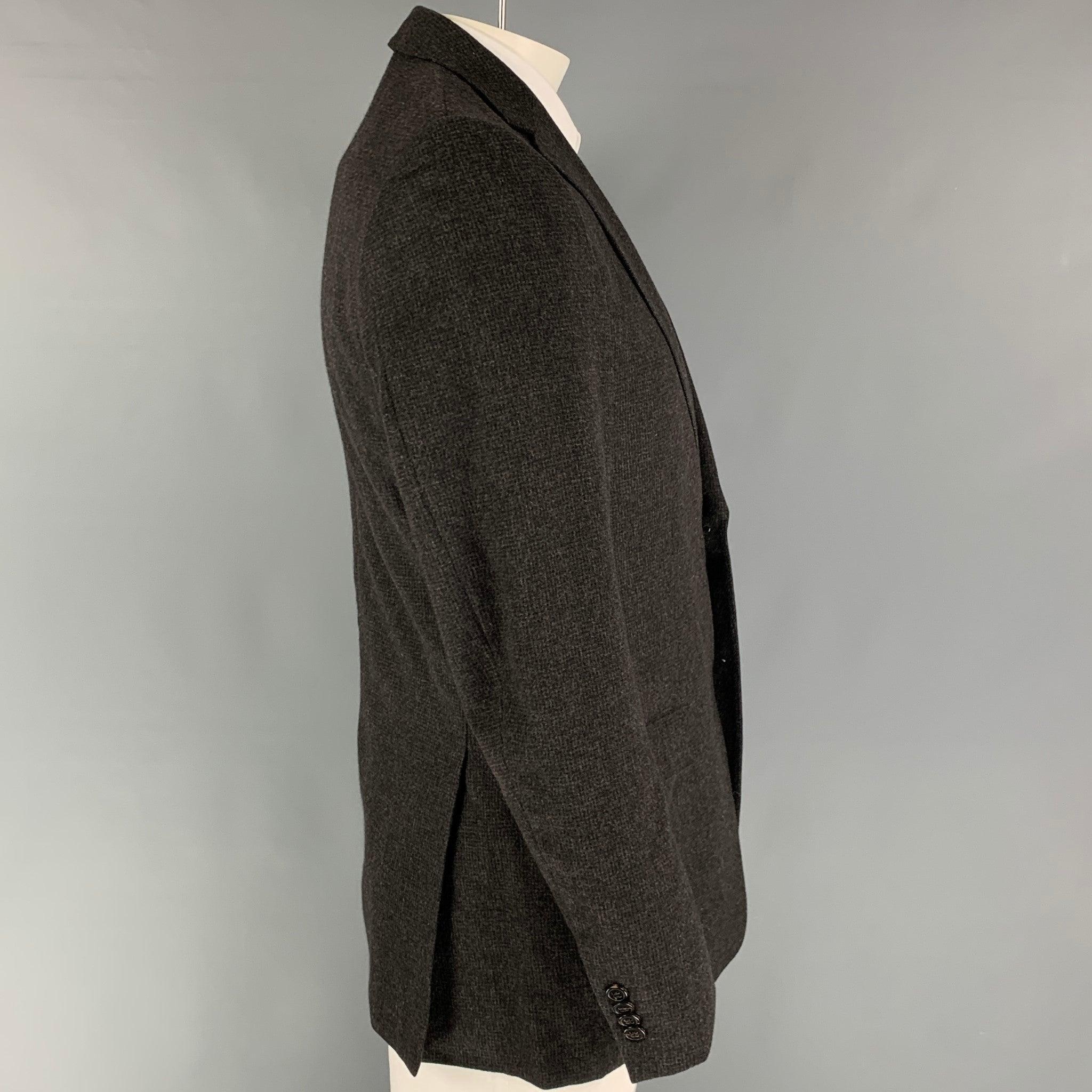 Z ZEGNA sport coat comes in a charcoal & grey grid wool / angora with a full liner featuring a notch lapel, flap pockets, double back vent, and a double button closure.
Very Good
Pre-Owned Condition. Missing one button.  

Marked:   50 L 