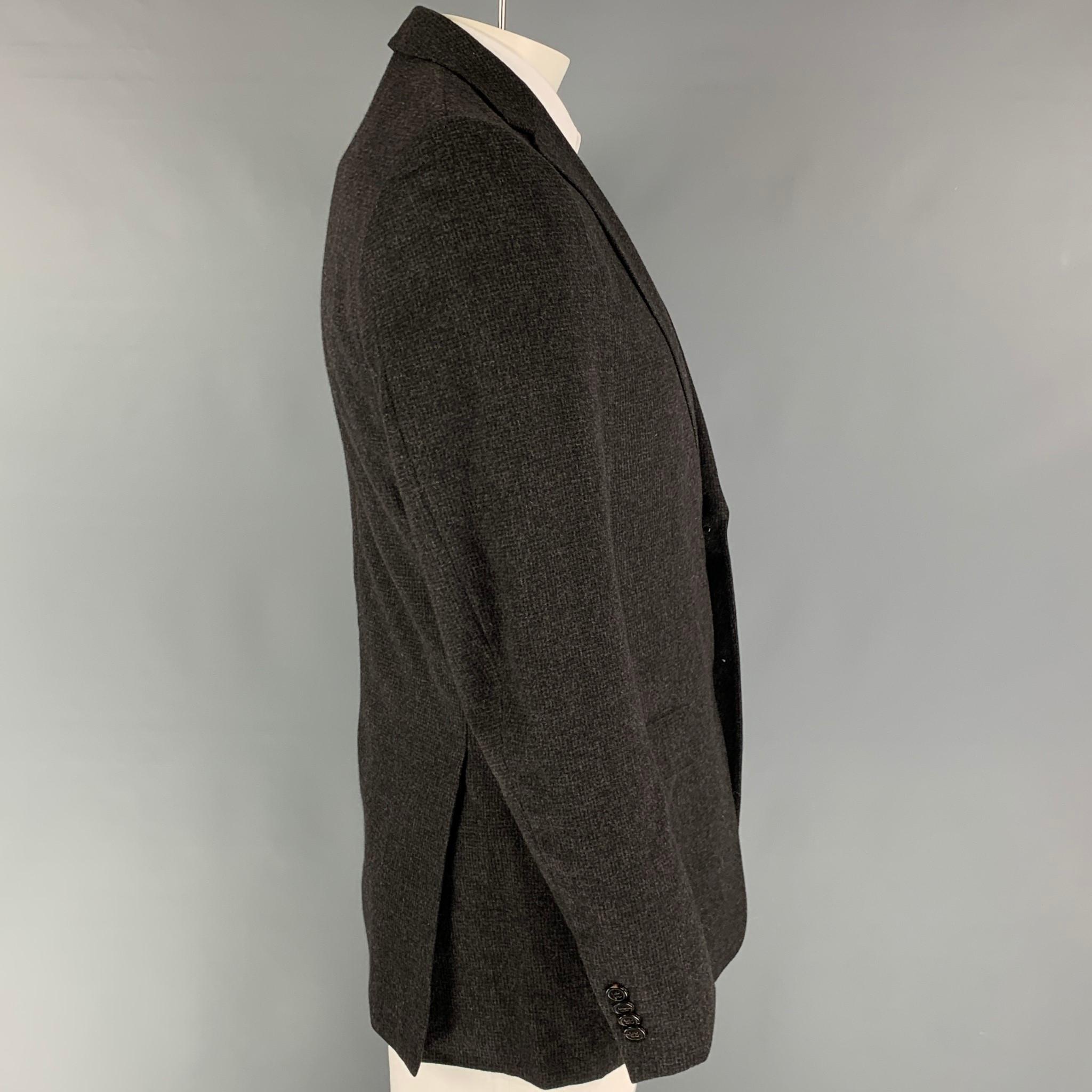 Z ZEGNA sport coat comes in a charcoal & grey grid wool / angora with a full liner featuring a notch lapel, flap pockets, double back vent, and a double button closure. 

Very Good Pre-Owned Condition. Missing one button.
Marked: 50