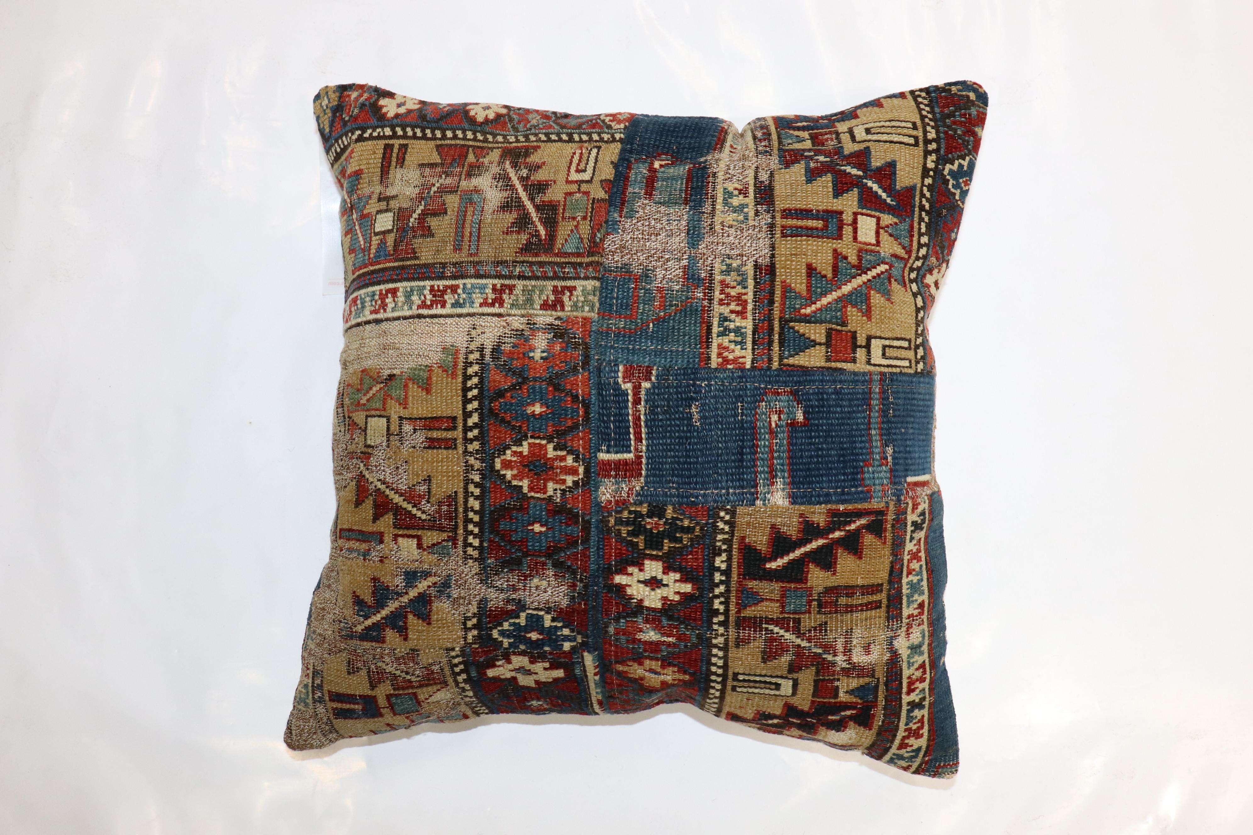 Pillow made from a 19th-century Caucasian rug done in a patchwork format with cotton back and zipper closure included.

Measures: 18'' x 18''.