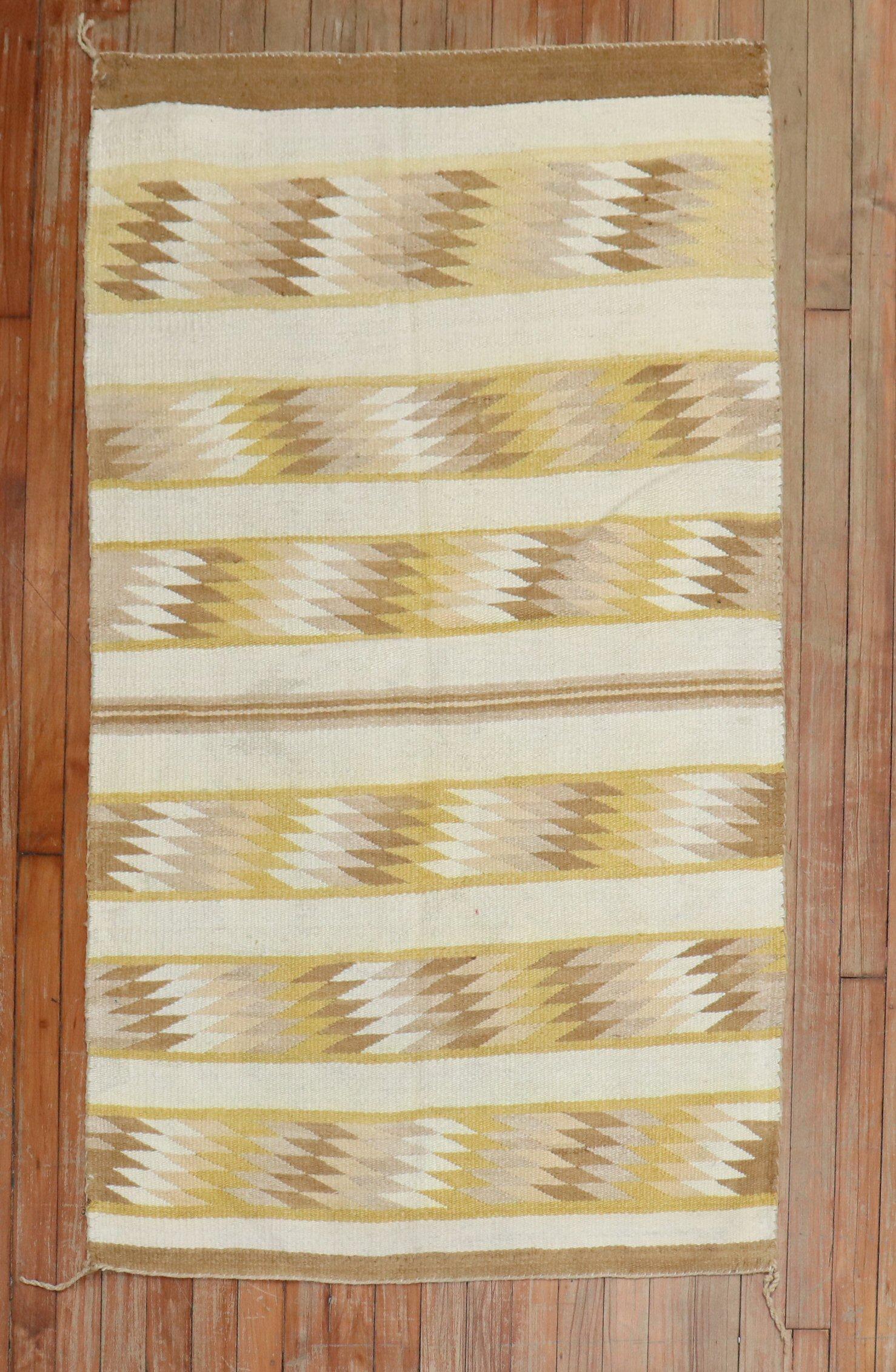 A highly decorative 20th-century American Navajo rug. Ivory, Yelow, and browns

Measures: 3'1'' x 4'11''.