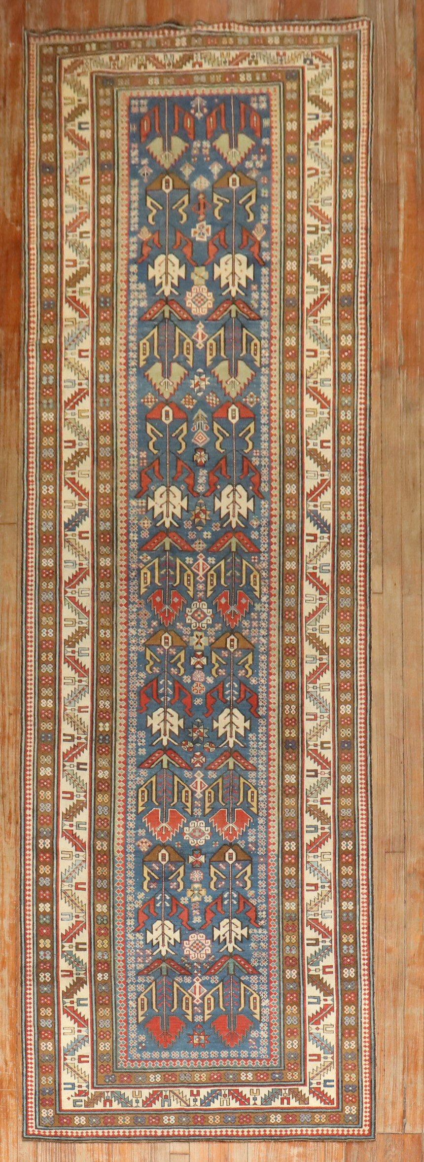 19th century kuba shirvan antique runner  with a tribal pattern  on a soft blue field

Measures: 3'5'' x 12'2''.