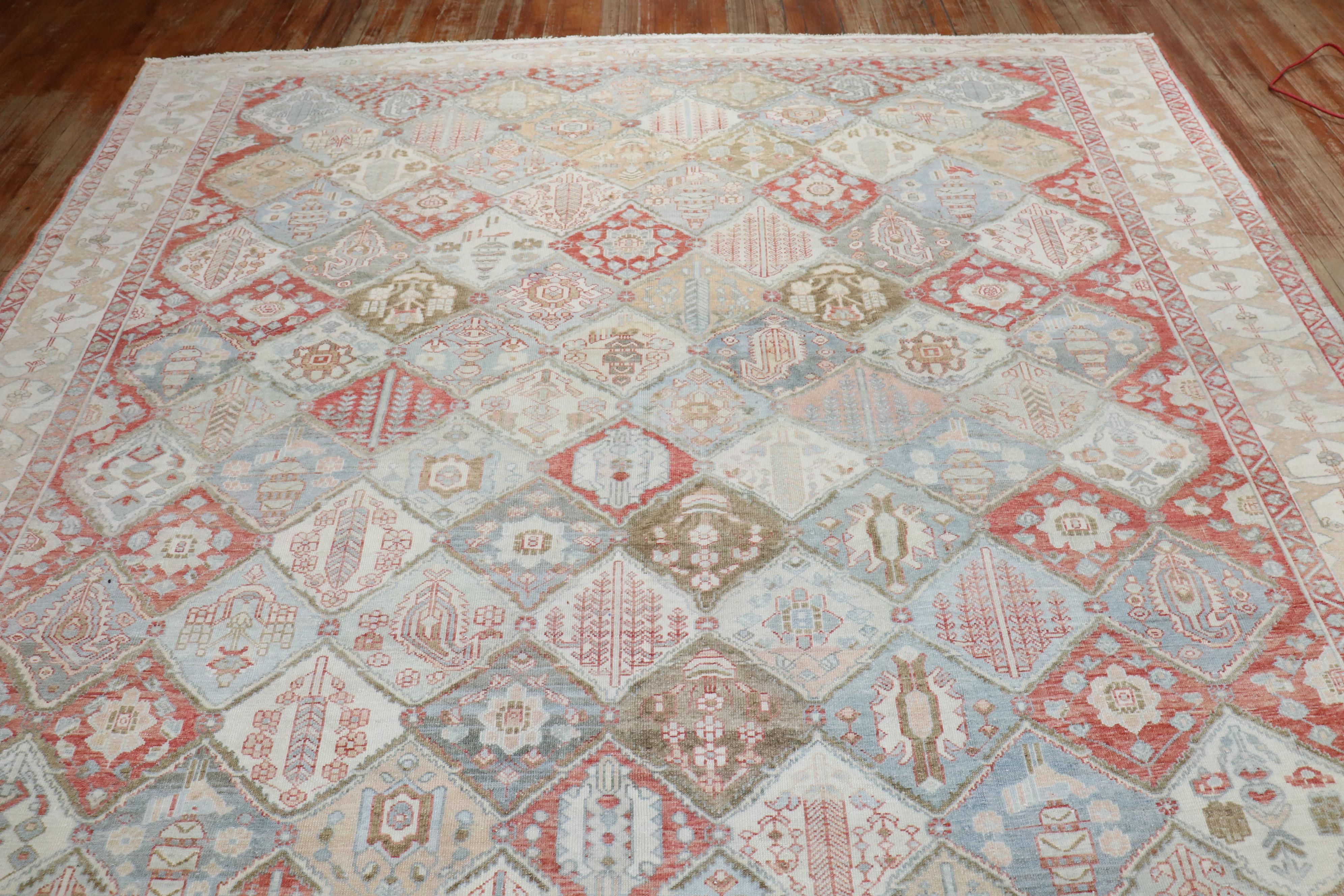A room size Geometric Persian Bakhtiari rug with an all-over garden design in rustic / earth tone colors throughout

Measures: 10'x 13'8'' circa 1920