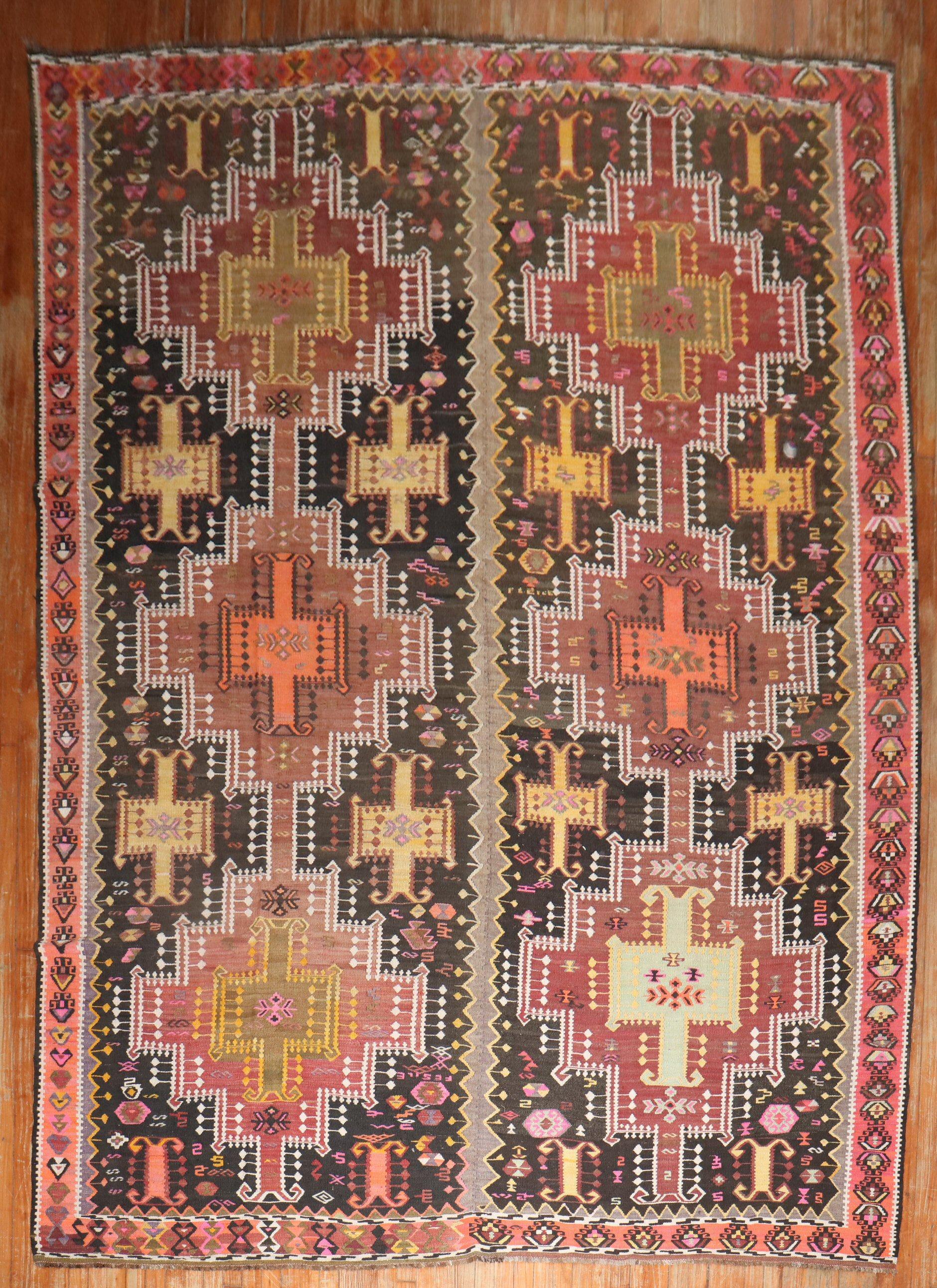 an early 20th Century Tribal Room size Turkish Kilim

Measures: 8'7” x 12'8''

With the Jijim weaving technique, different colored threads are applied between the weft and warp threads, on the reverse of the weave. It is often used to decorate a