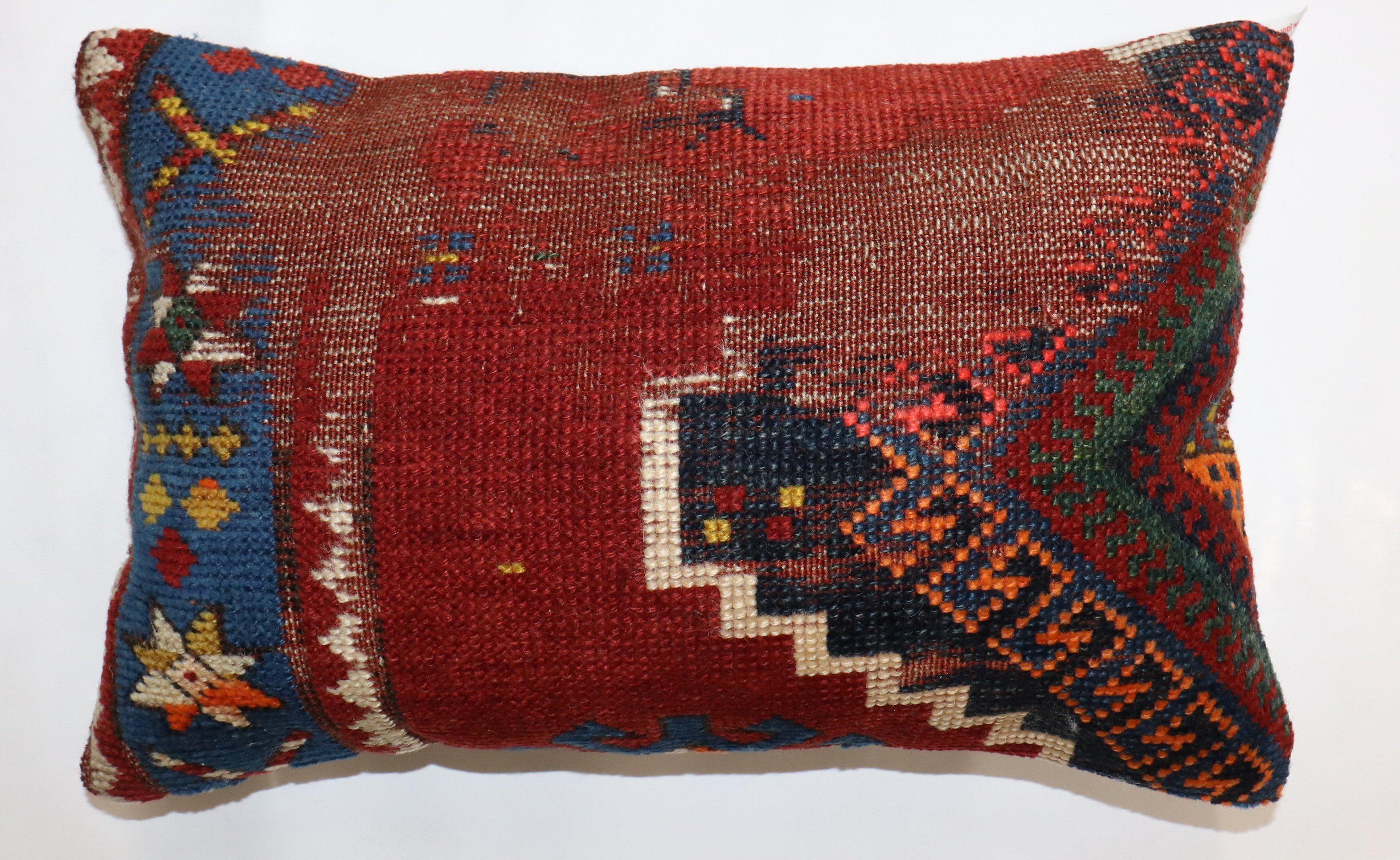 Lumbar size pillow made from a 19th-century Caucasian rug. 

Measures: 13'' x 21''.