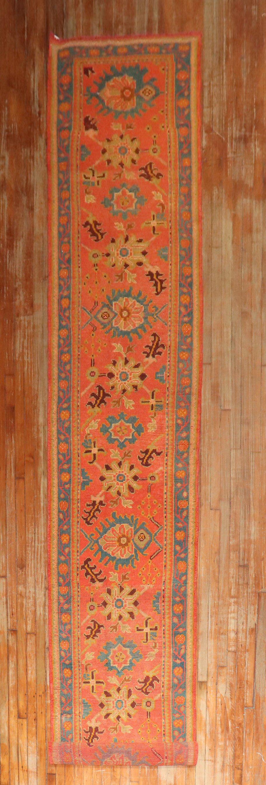 An early 20th century colorful bright orange field long and narrow Oushak Runner. Not many old runners made this long from the Oushak region. this was most probably a custom order at the time

2'11'' x 18'10''.