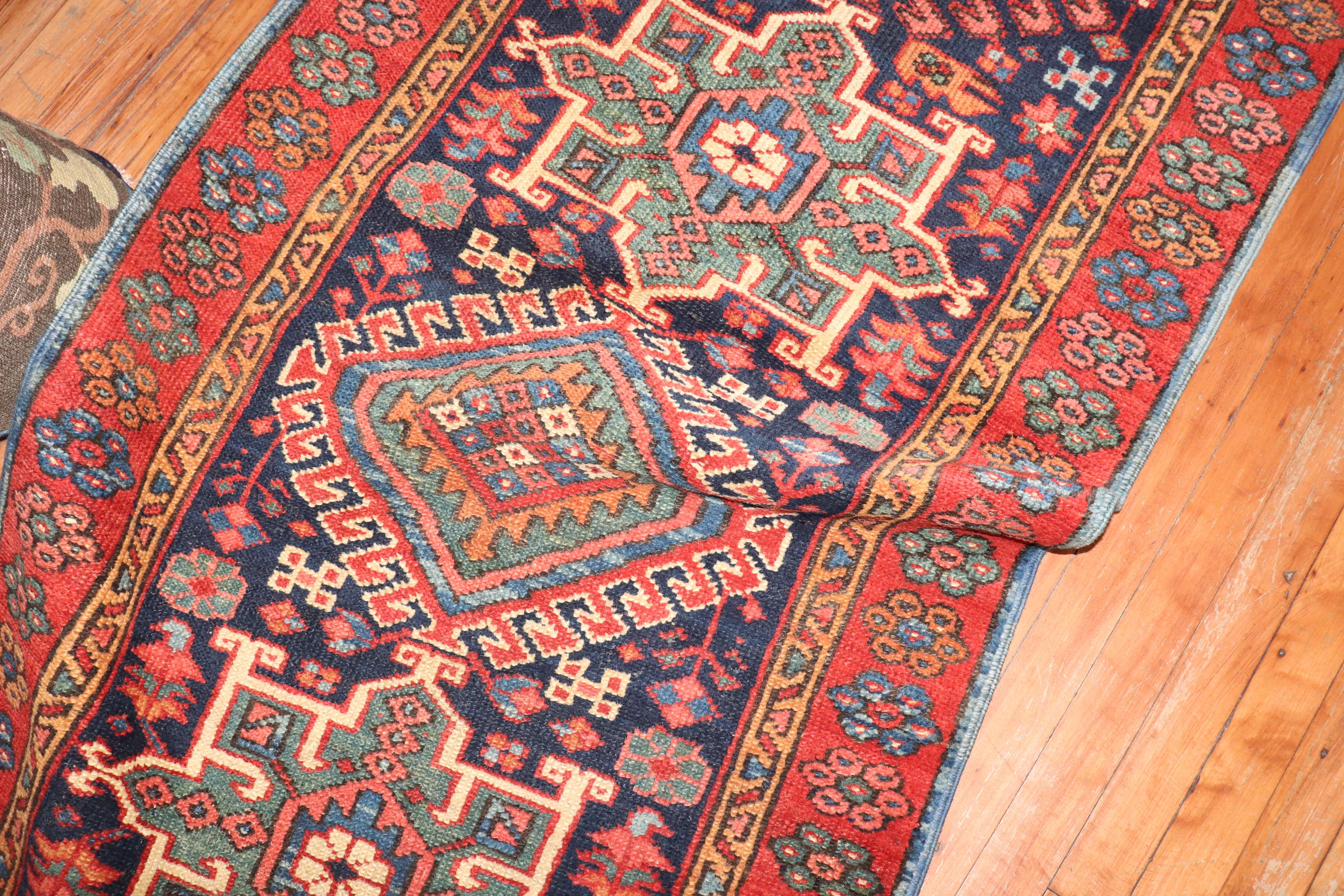 Colorful antique Persian Heriz runner from the 2nd quarter of the 20th century with an all-over geometric motif on a navy blue ground.

2'10'' x 9'