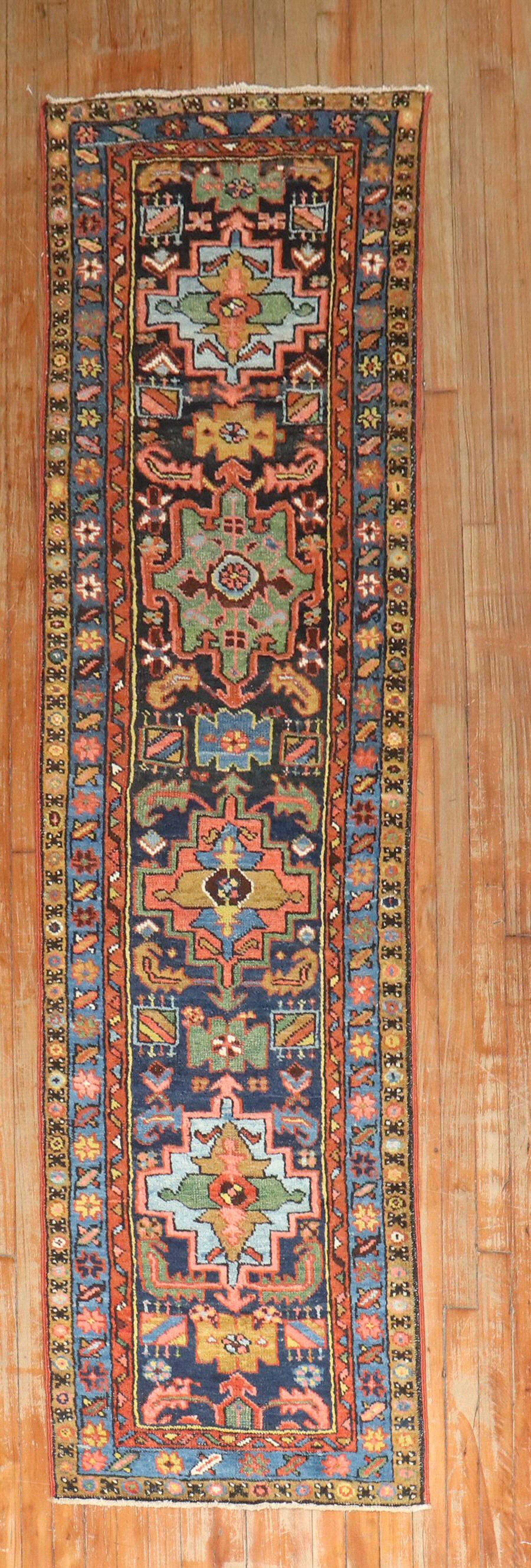 Colorful antique Persian Heriz Karadja runner from the 2nd quarter of the 20th century with an all-over geometric motif on a navy blue ground.

2'3'' x 8'6''.
