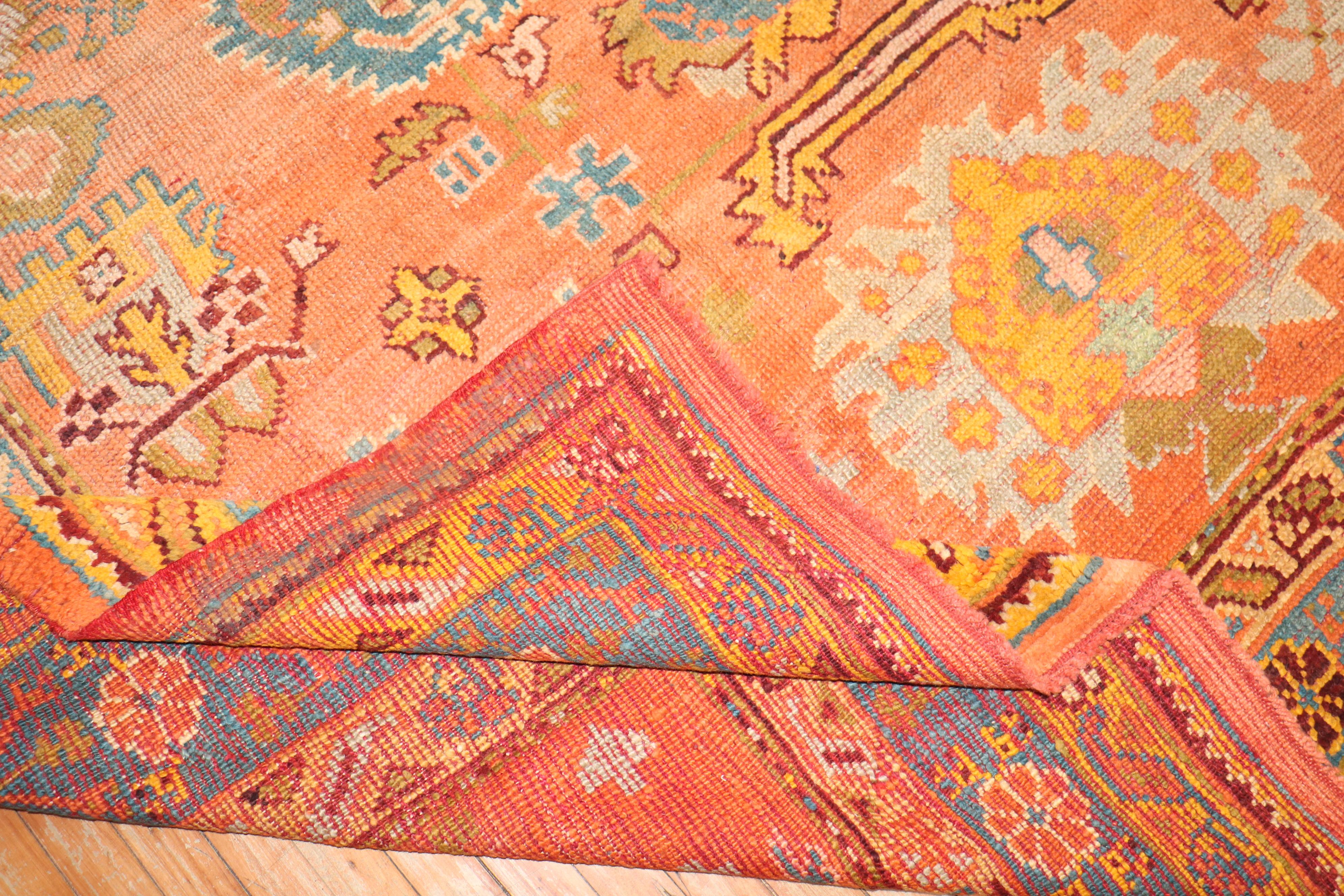 An early 20th-century orange field antique Oushak square rug

Measures: 9' x 10'9”.