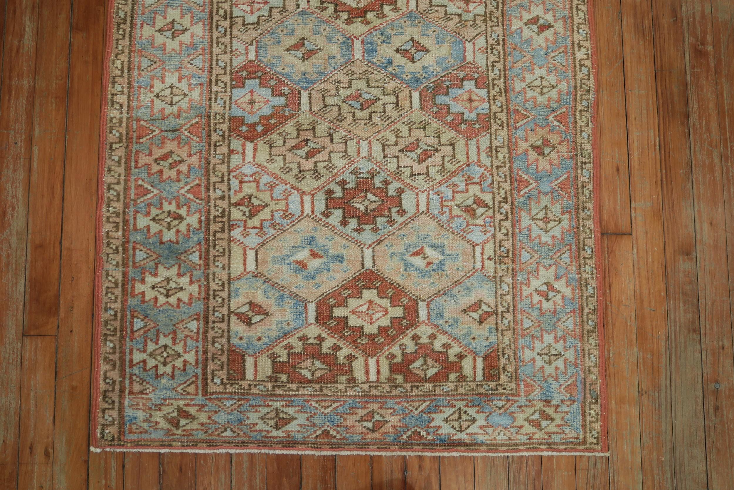 This is a one-of-a-kind Persian Heriz rug from circa 1930. It has a geometric design with dominant accents in camel, blue, and rust.

Details
rug no.	j1556
size	2' 10