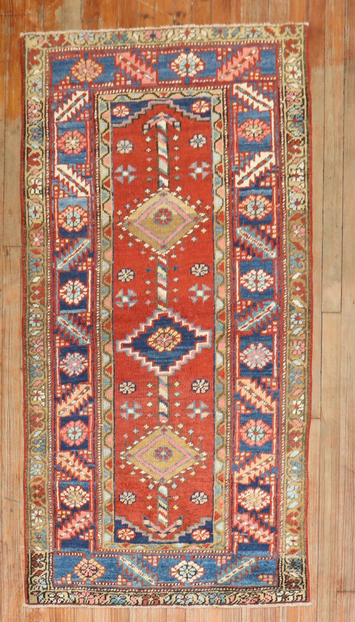 An early 20th-centuryPersian heriz rug. 

Measures: 2'11'' x 5'9''

Heriz carpets are beloved for their versatility. Their geometry complements modern furnishings and their warm colors and artistic depth enhance antiques of all kinds. Their richness