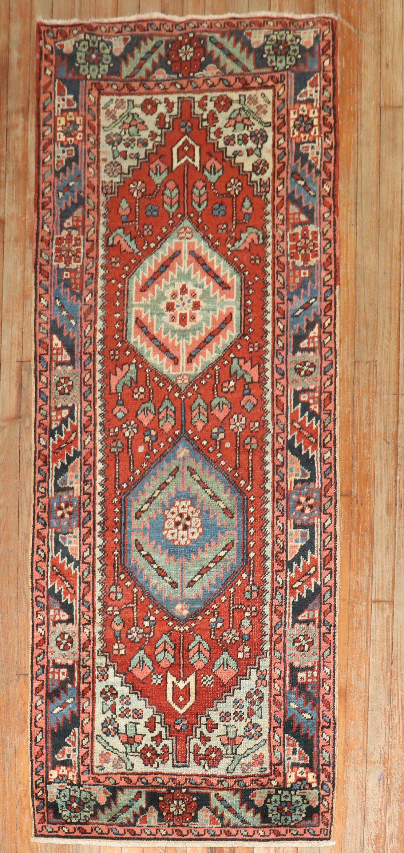An early 20th-century Persian heriz small runner 

Measures: 2'8'' x 6'10''

Heriz carpets are beloved for their versatility. Their geometry complements modern furnishings and their warm colors and artistic depth enhance antiques of all kinds. Their