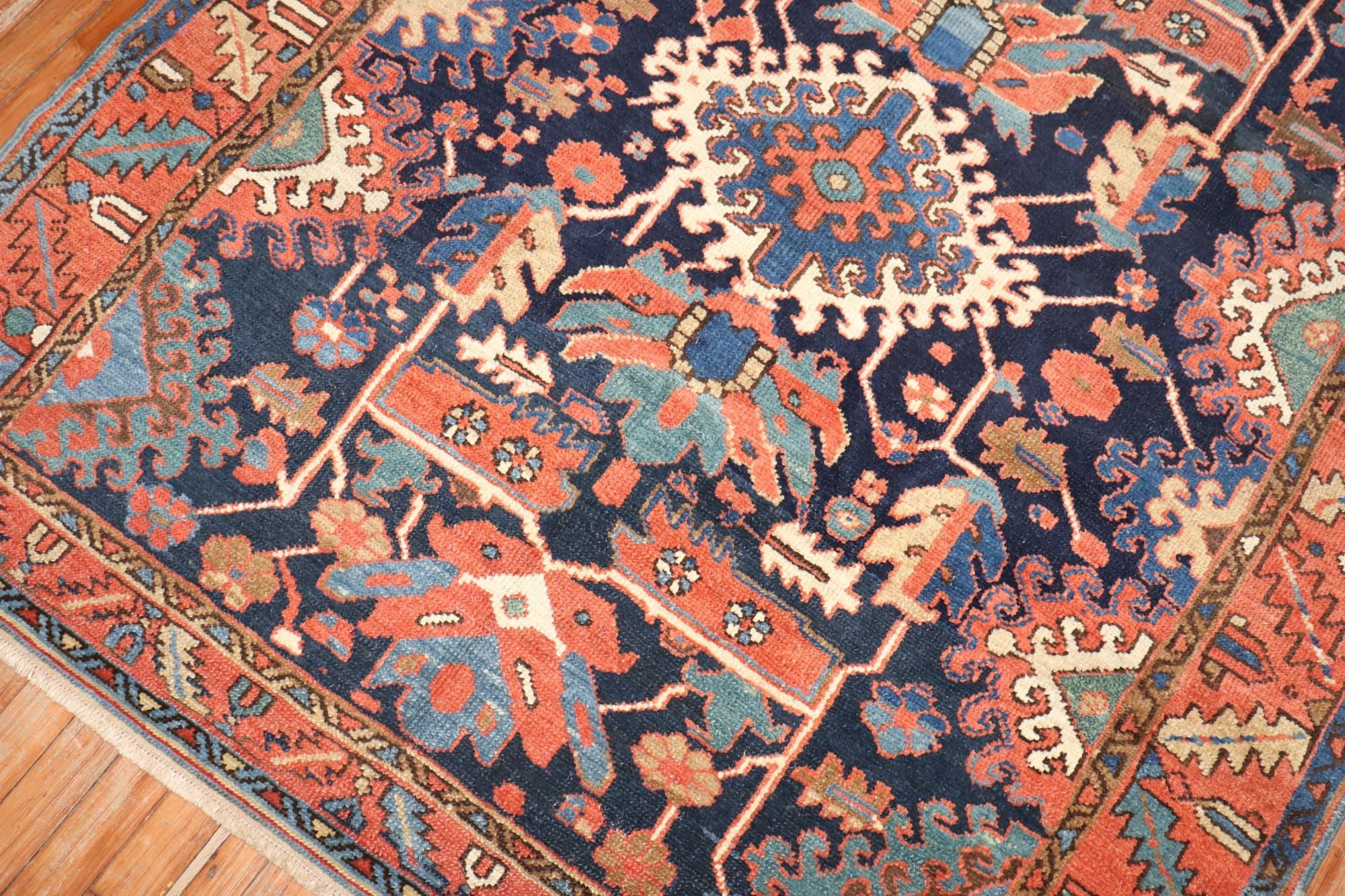 An early 20th century traditional navy blue field Persian Heriz carpet with a geometric all over design.

Measures: 5'x 5'8
