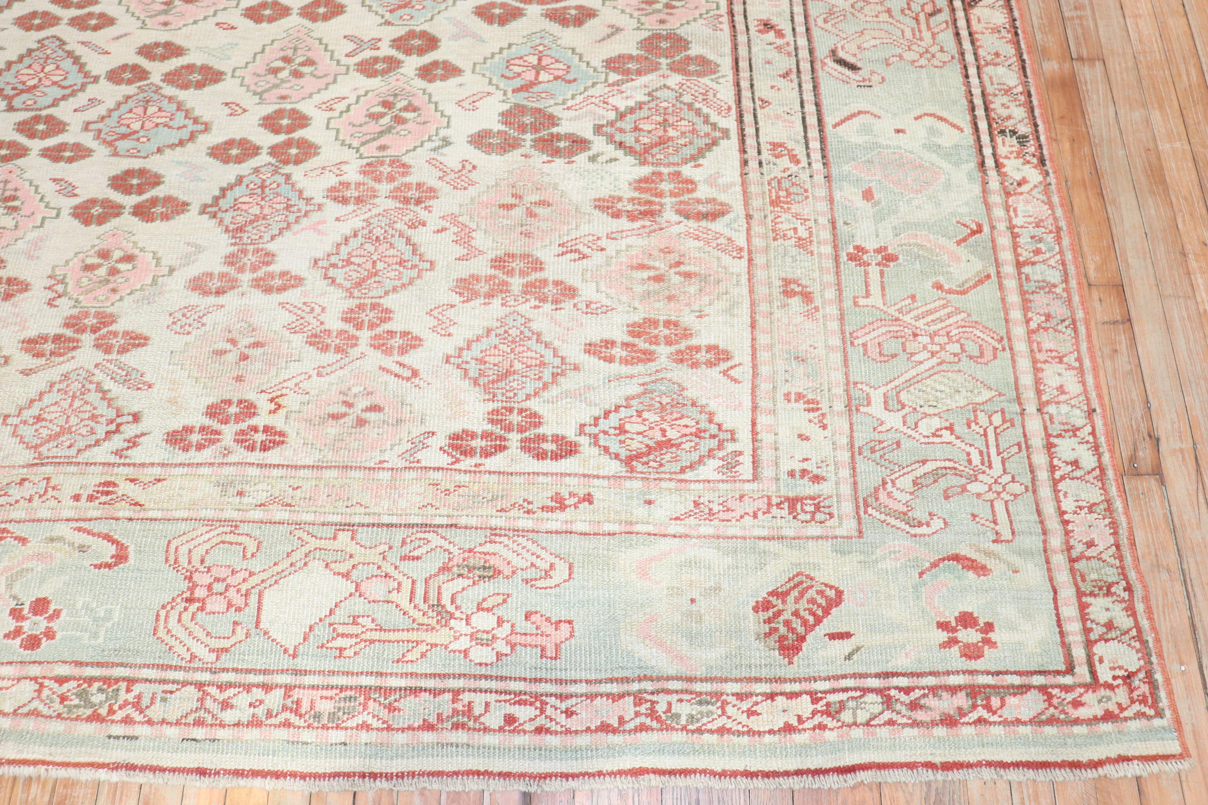 an early 20th century small room size Turkish Ghiordes decorative rug.

Measures: 10'3'' x 14'3''.