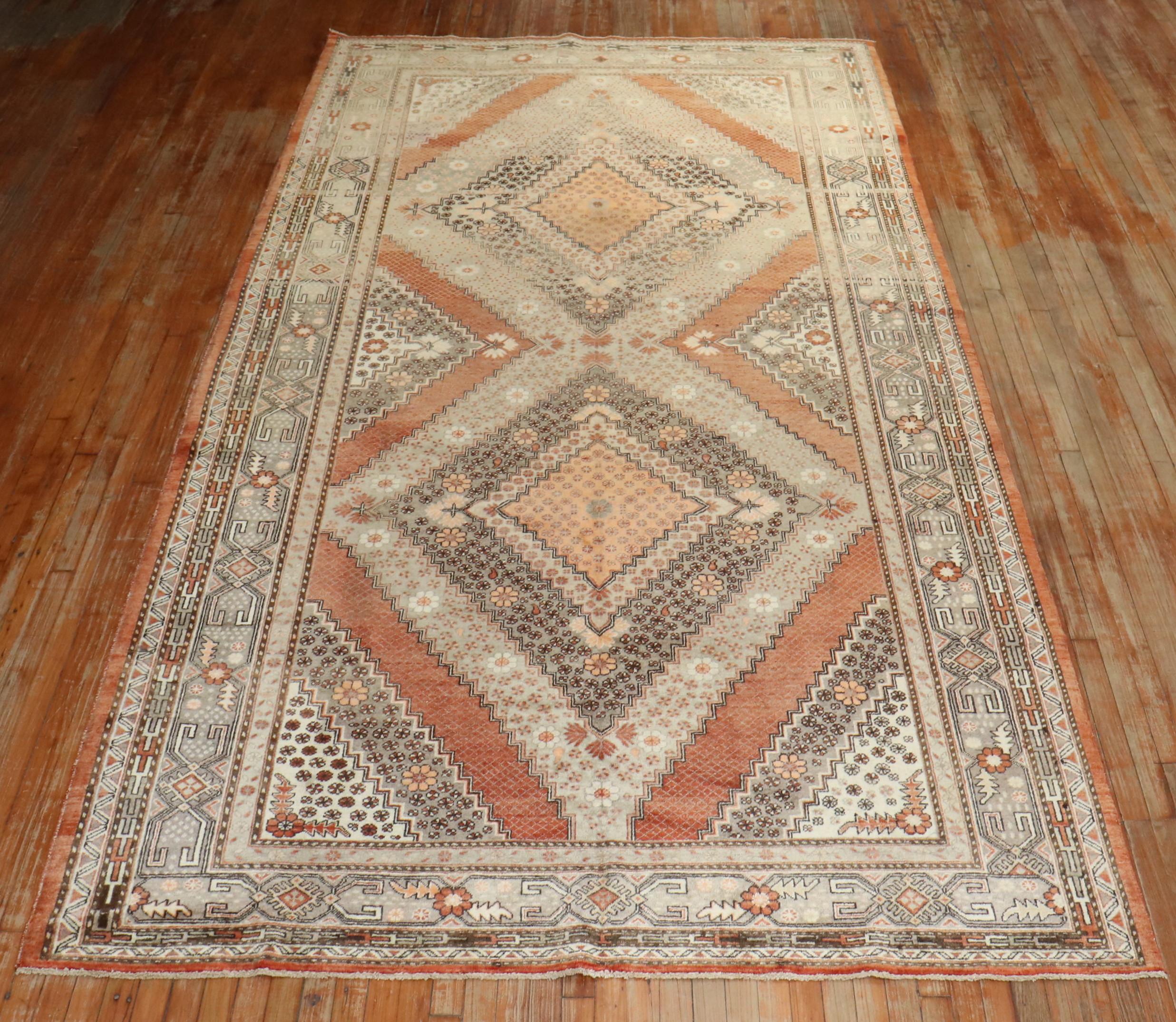 20th century one of a kind gallery size Khotan rug with 2 large medallions on an apricot color ground, dominant accents in orange and gray,

measures: 7 x 13'6