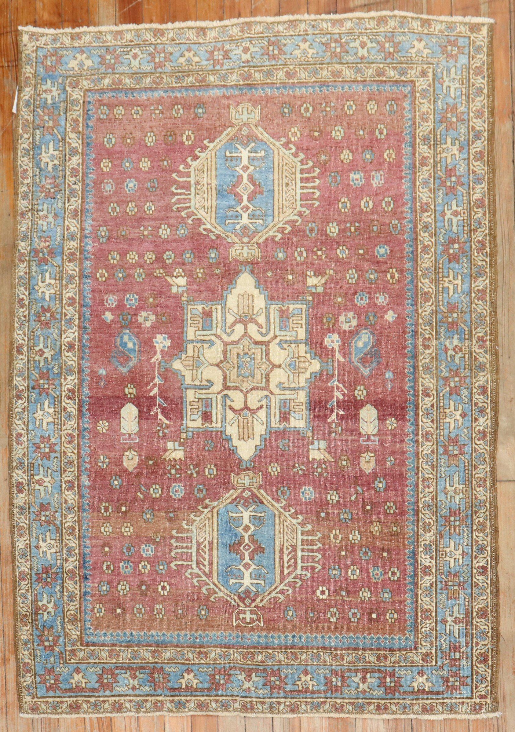 Persian Heriz Tribal scatter rug with a background color in rare aubergine from the 2nd quarter of the 20th century

Measures: 3'4” x 4'9”.